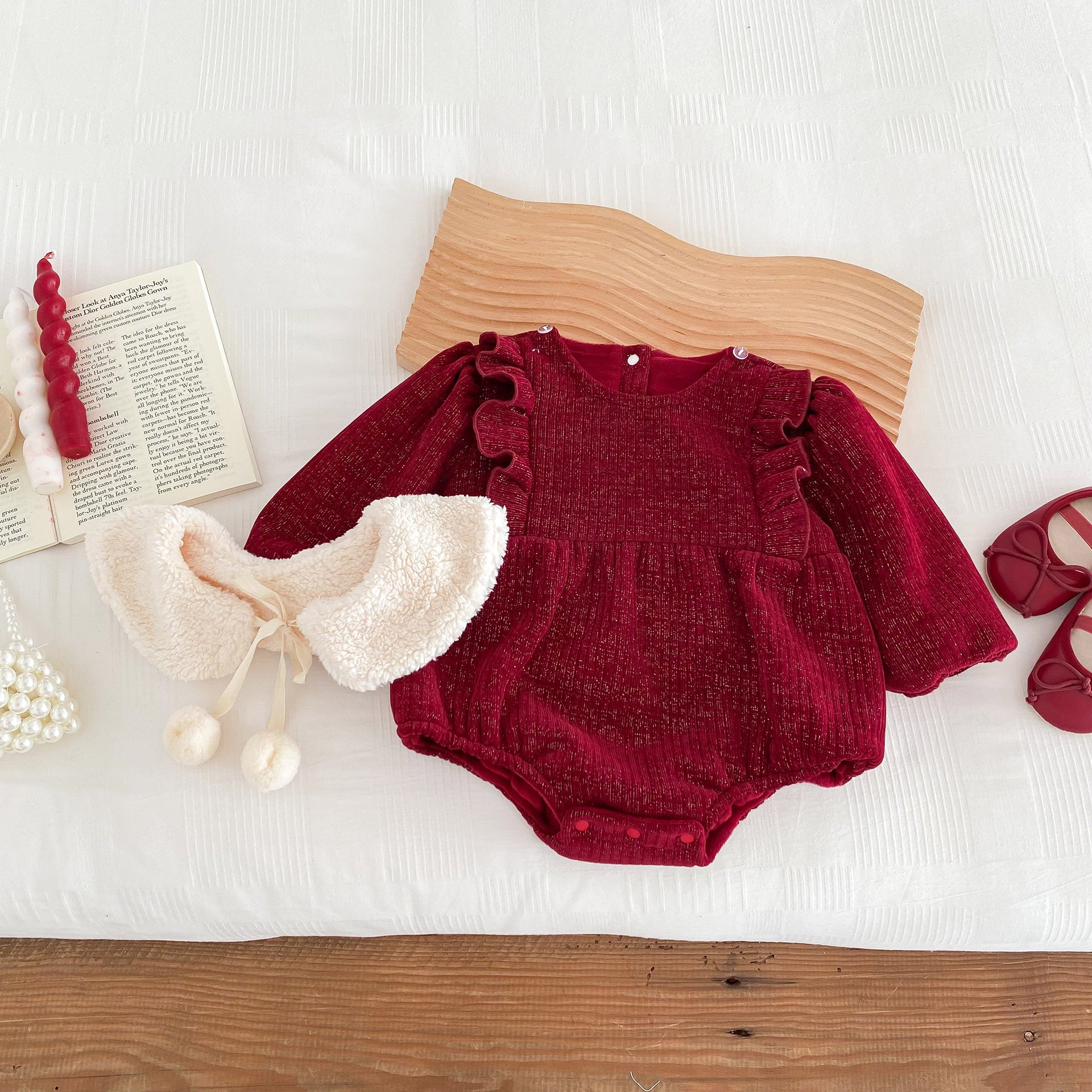 A vibrant red long-sleeve top for baby girls featuring ruffles, made from a soft cotton and polyester blend, perfect for cooler weather.