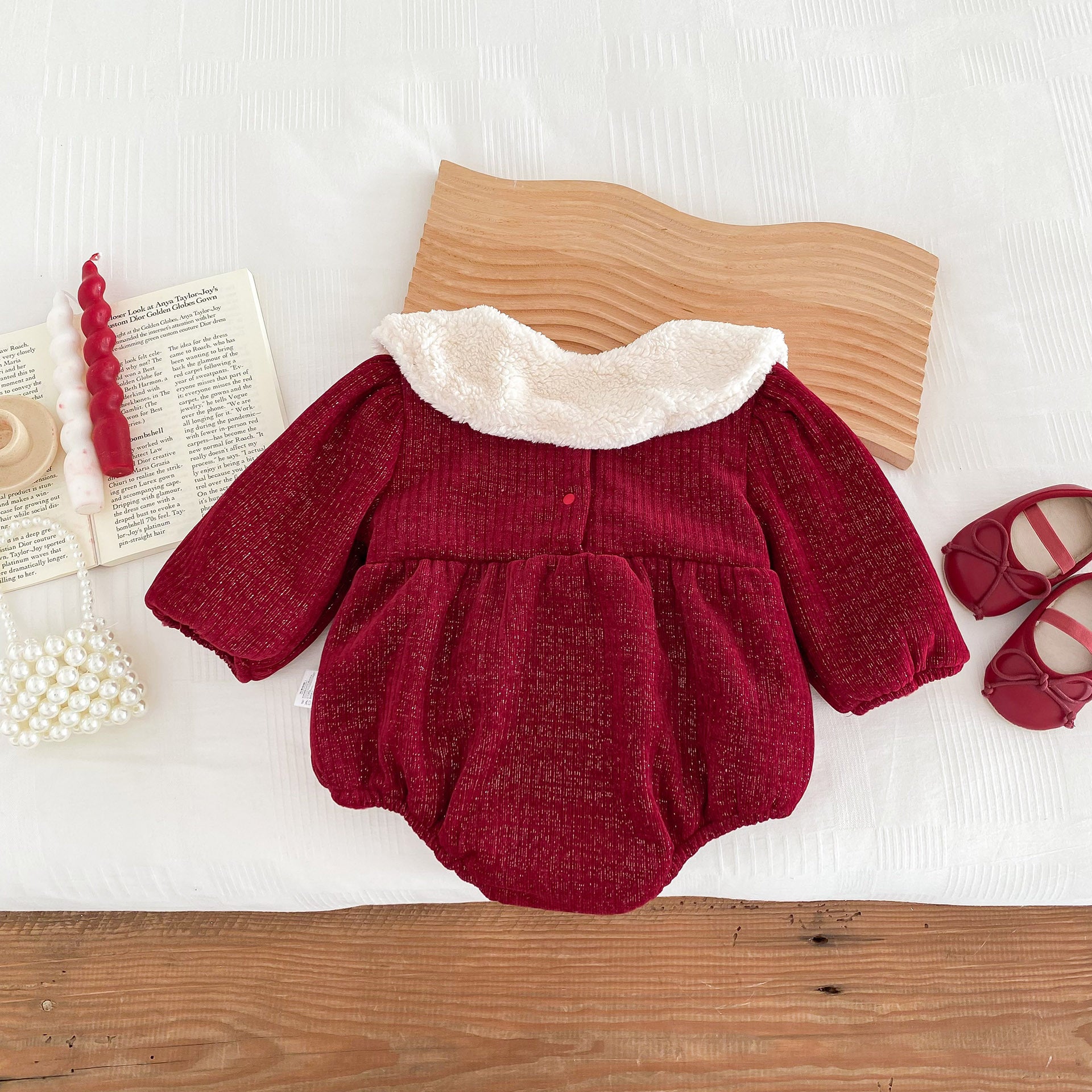 A vibrant red long-sleeve top for baby girls featuring ruffles, made from a soft cotton and polyester blend, perfect for cooler weather.