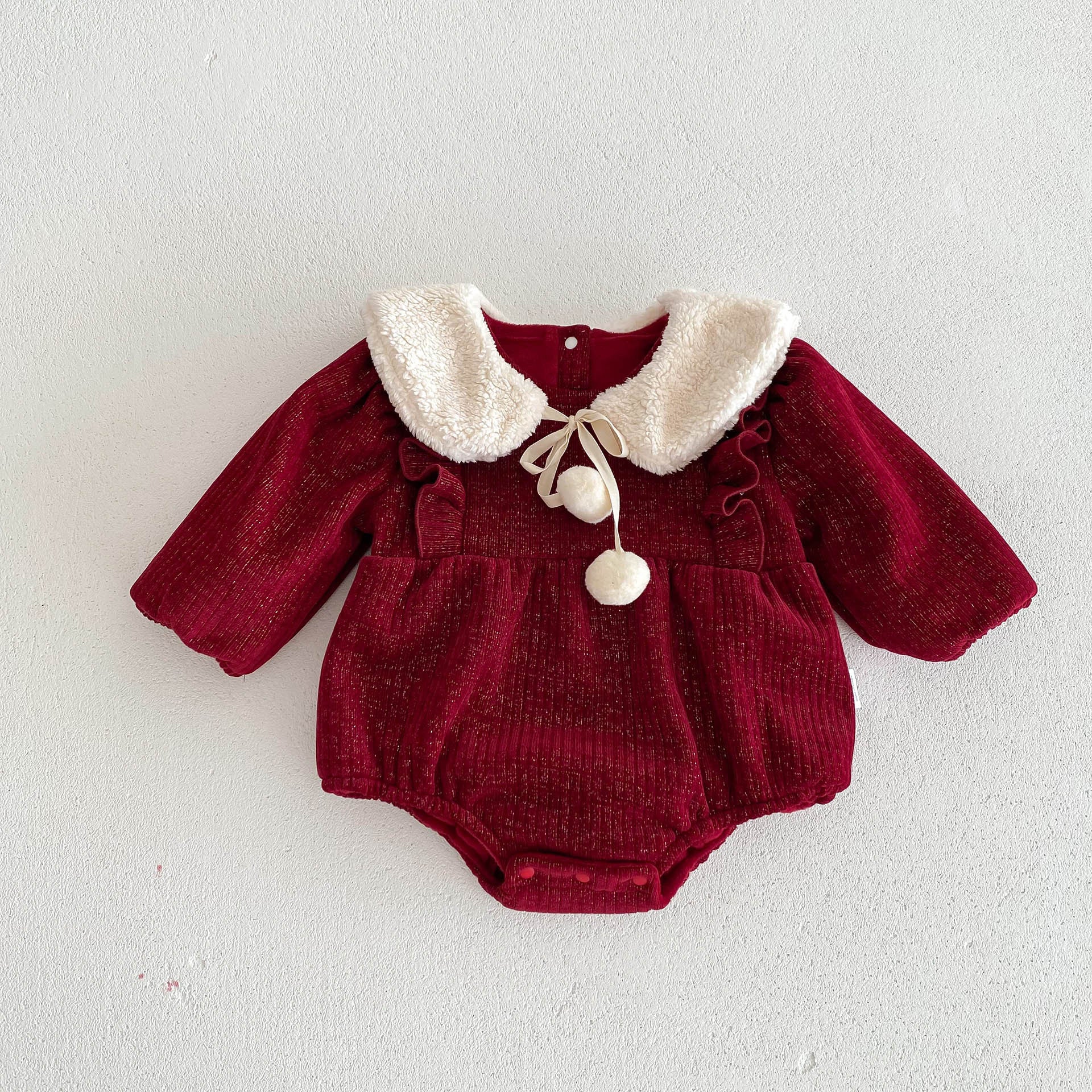 A vibrant red long-sleeve top for baby girls featuring ruffles, made from a soft cotton and polyester blend, perfect for cooler weather.