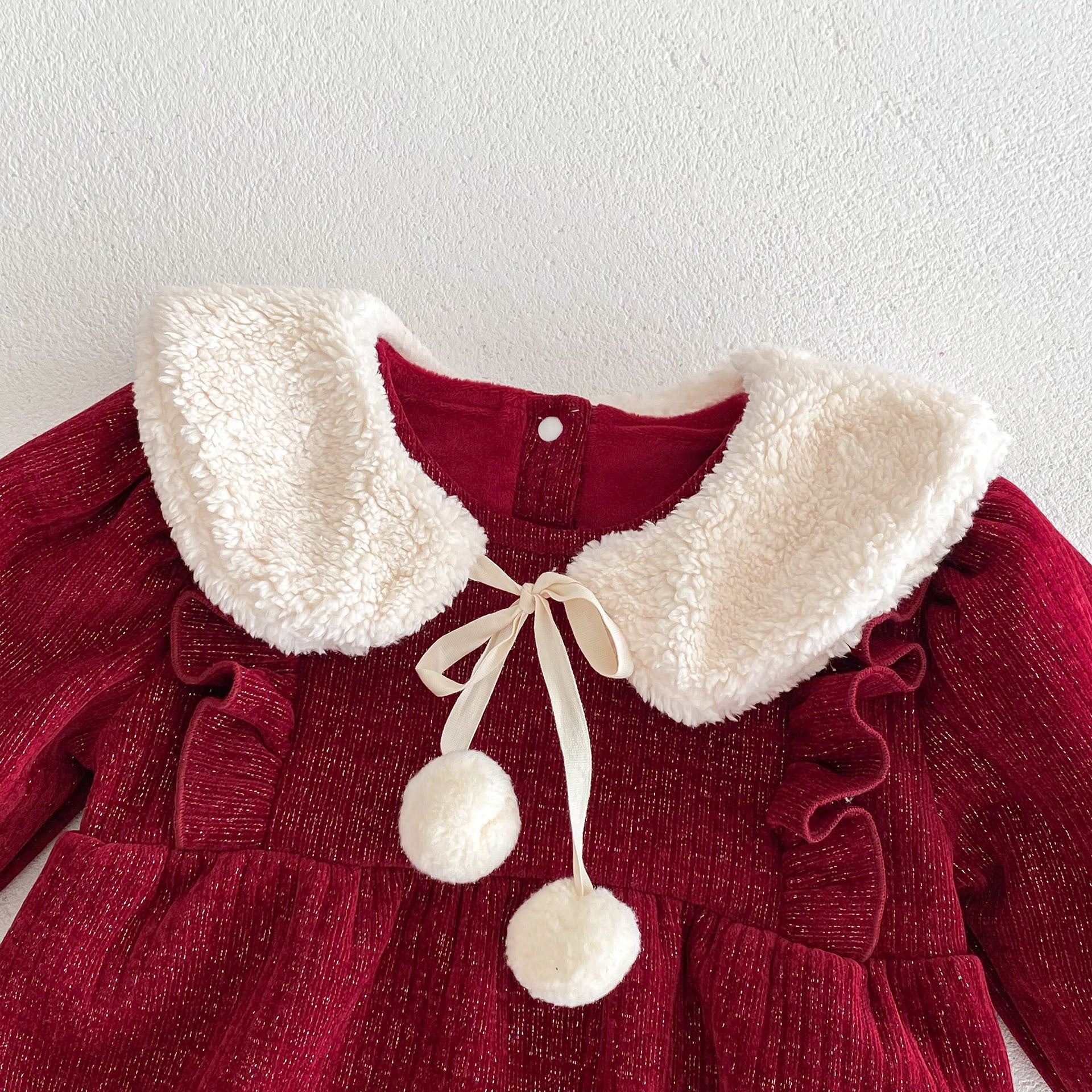 A vibrant red long-sleeve top for baby girls featuring ruffles, made from a soft cotton and polyester blend, perfect for cooler weather.