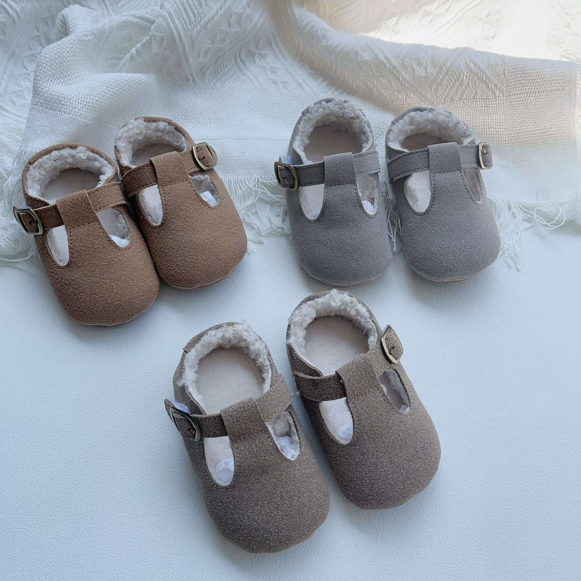 New Arrival Winter Baby Girl Solid Color Plush Warm Anti-Slip Shoes in green, grey, and brown, showcasing their soft material and anti-slip sole.