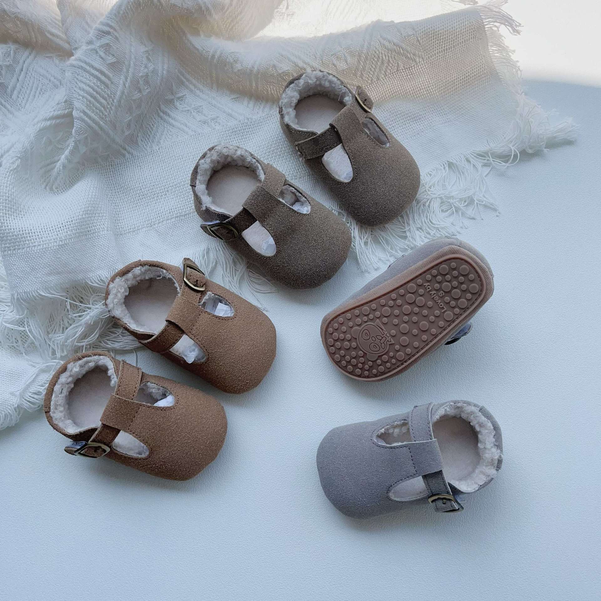 New Arrival Winter Baby Girl Solid Color Plush Warm Anti-Slip Shoes in green, grey, and brown, showcasing their soft material and anti-slip sole.