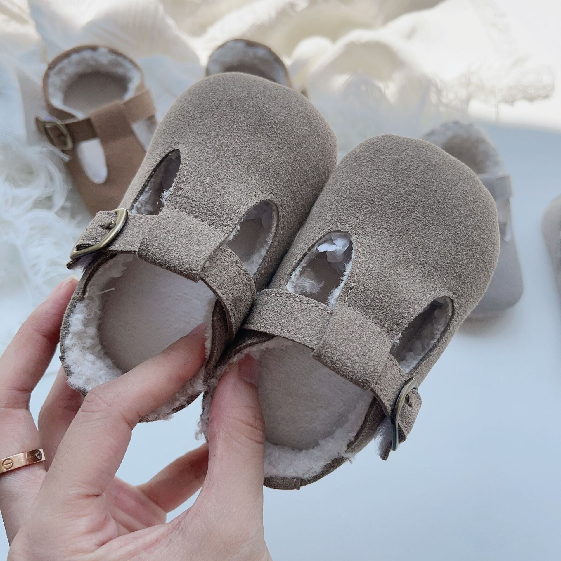 New Arrival Winter Baby Girl Solid Color Plush Warm Anti-Slip Shoes in green, grey, and brown, showcasing their soft material and anti-slip sole.