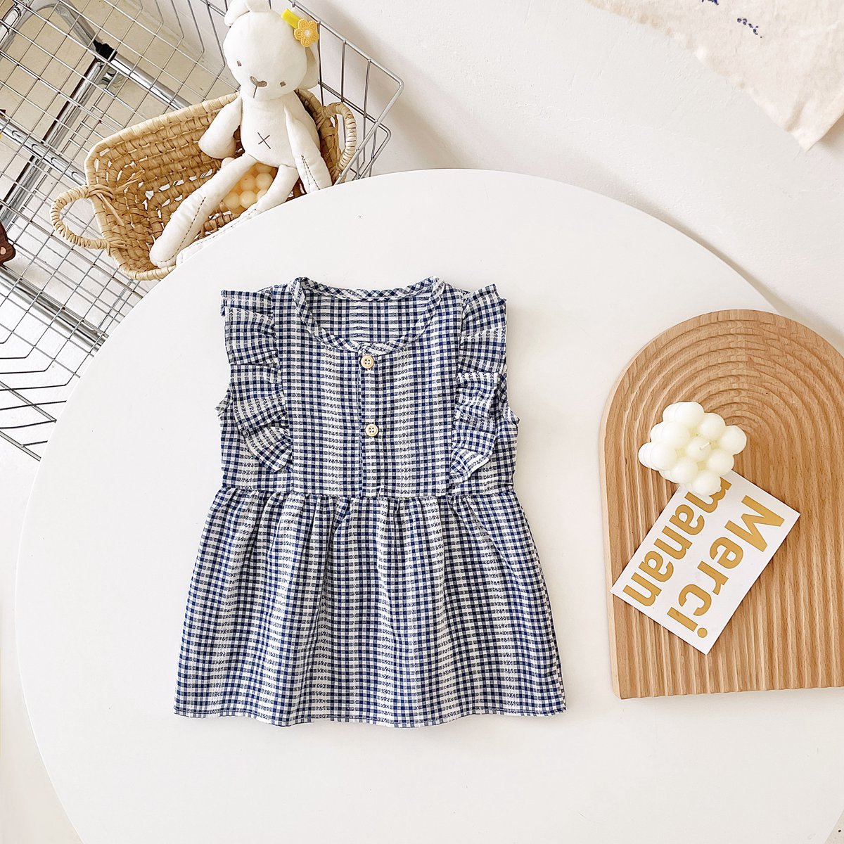 A stylish summer dress for baby girls featuring a plaid pattern in vibrant colors, made from soft cotton fabric.