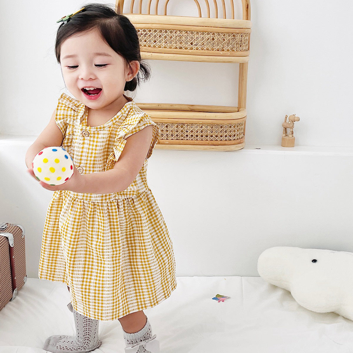 A stylish summer dress for baby girls featuring a plaid pattern in vibrant colors, made from soft cotton fabric.