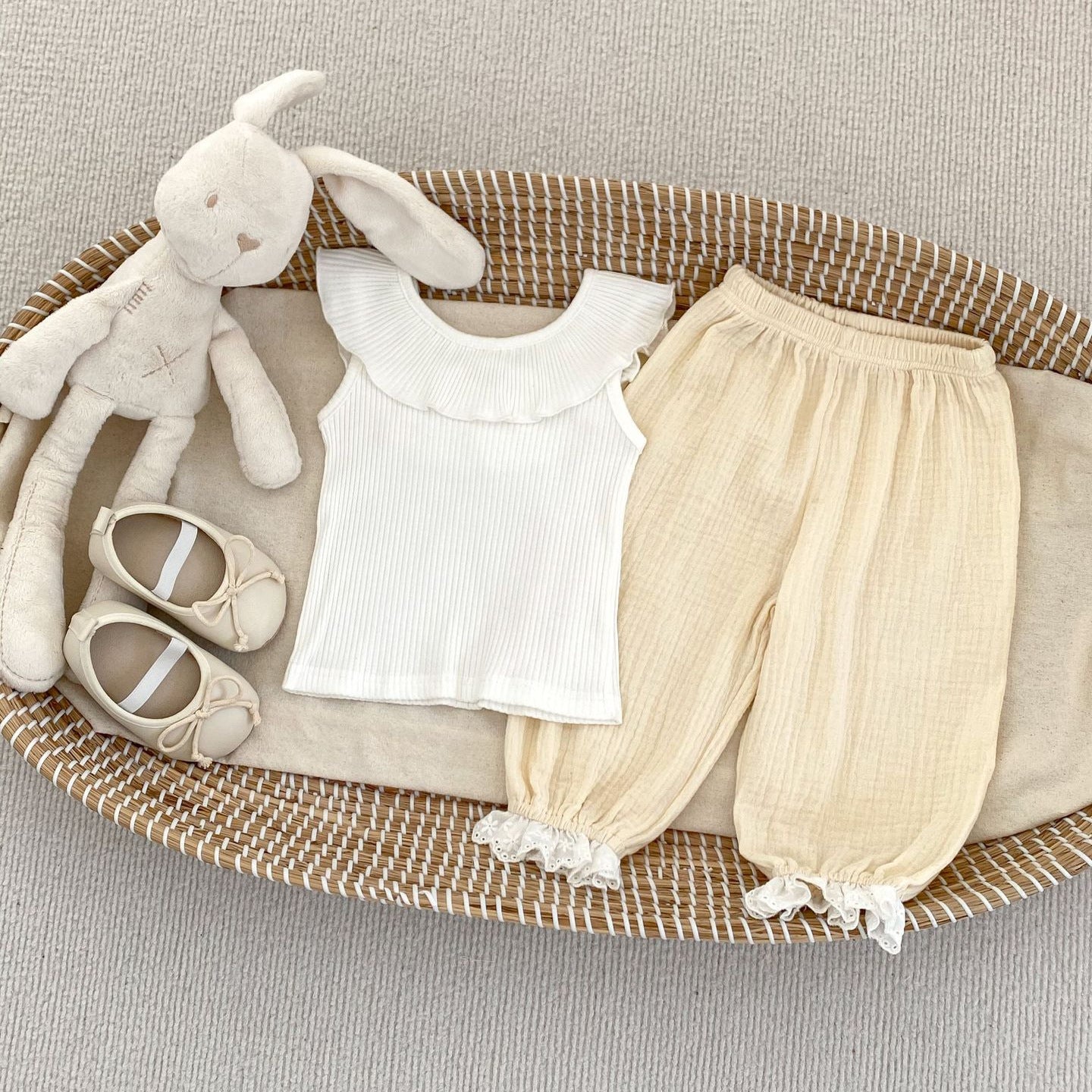 A cute summer dress for baby girls featuring lace trim, available in white, pink, green, and beige, made from breathable cotton.