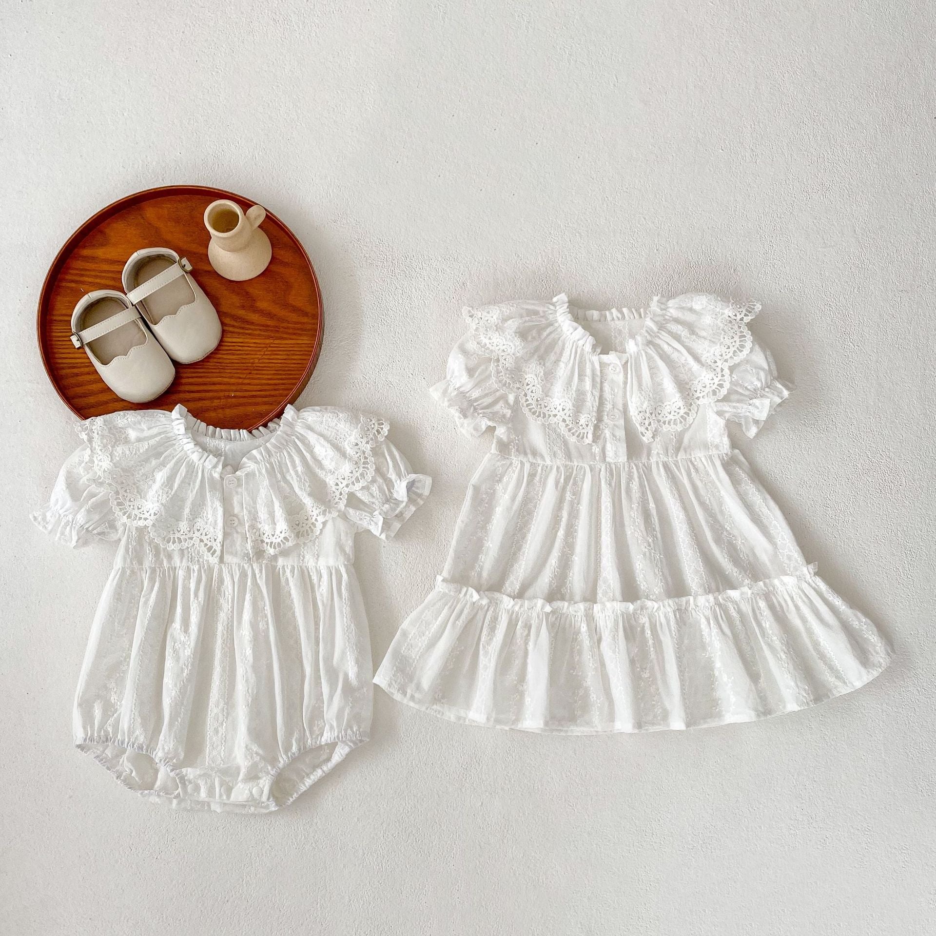 A stylish summer outfit for baby girls featuring a hollow out collar and short sleeves in beige and apricot colors.