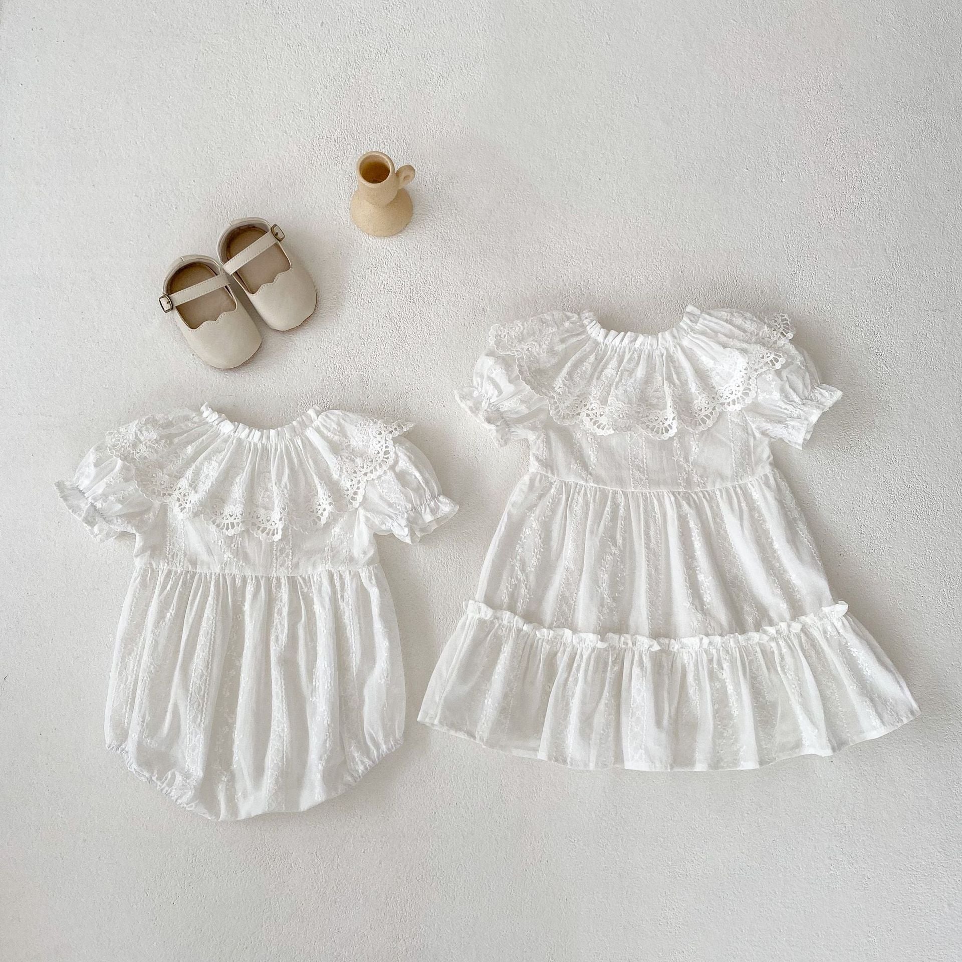 A stylish summer outfit for baby girls featuring a hollow out collar and short sleeves in beige and apricot colors.