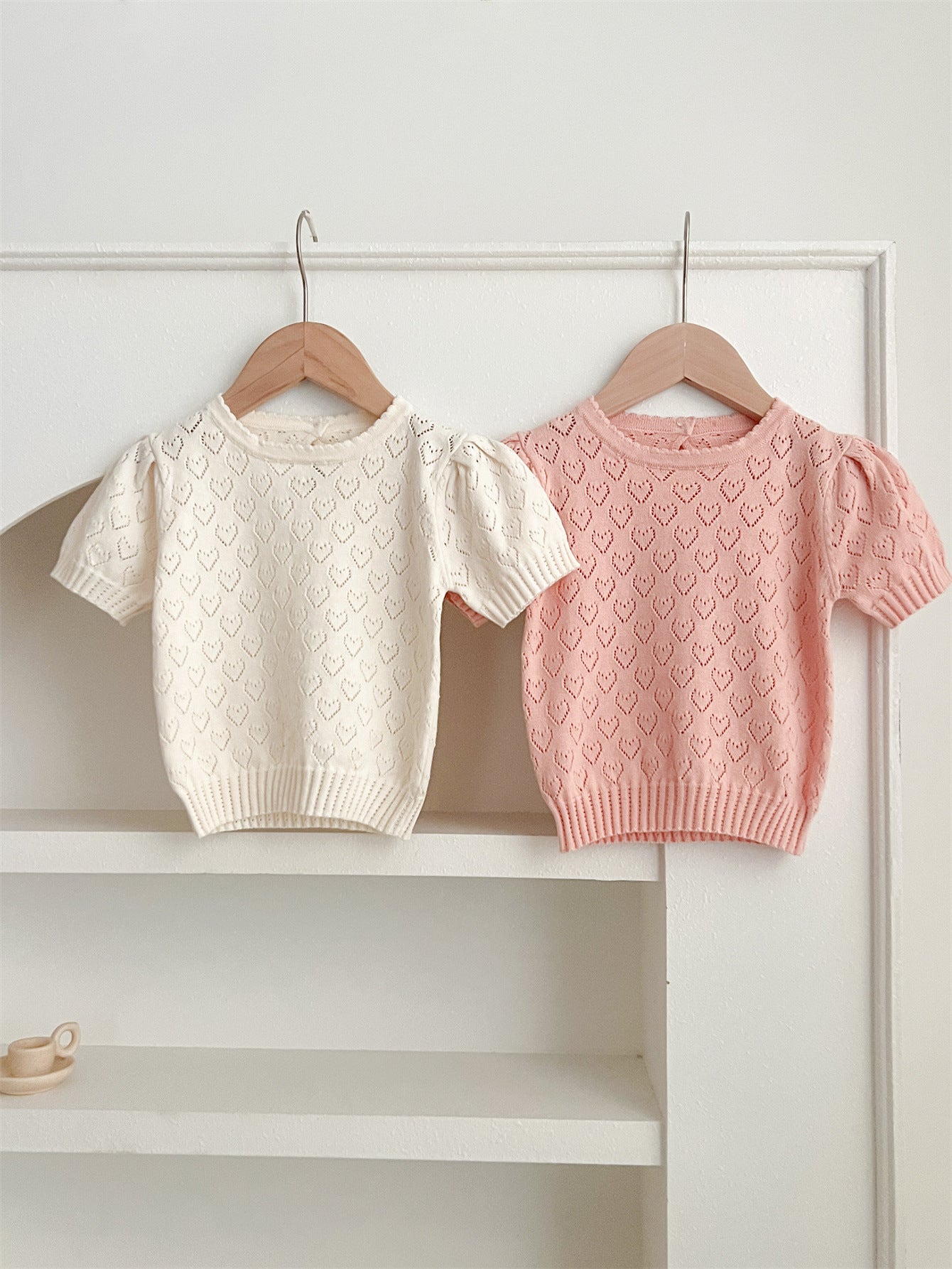 Summer baby girls knit hollow out heart pattern short in pink and beige, made from soft cotton, perfect for warm weather.