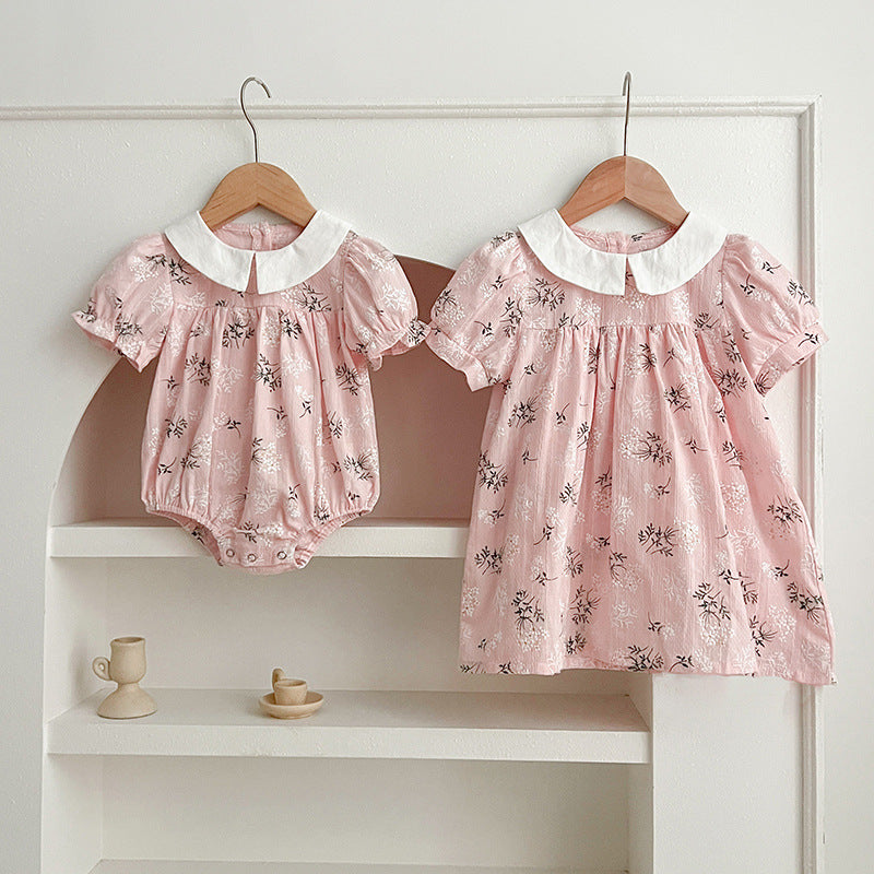 A collection of summer girls' onesies featuring Peter Pan collars in pink, light pink, blue, and light blue colors with floral patterns.