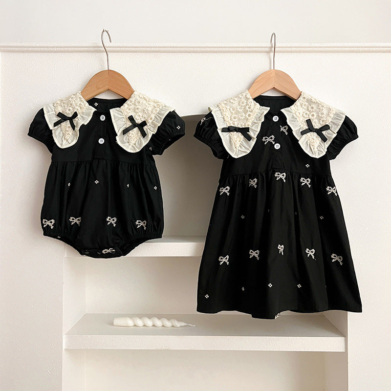 A cute summer dress for baby girls featuring a floral pattern and collar, available in black and apricot colors.