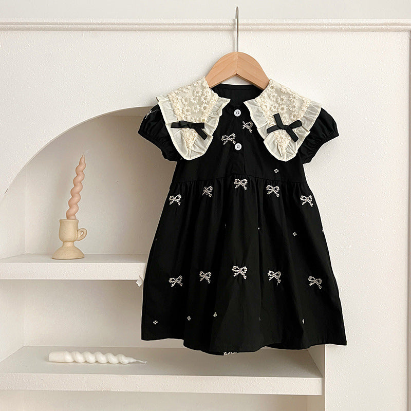 A cute summer dress for baby girls featuring a floral pattern and collar, available in black and apricot colors.