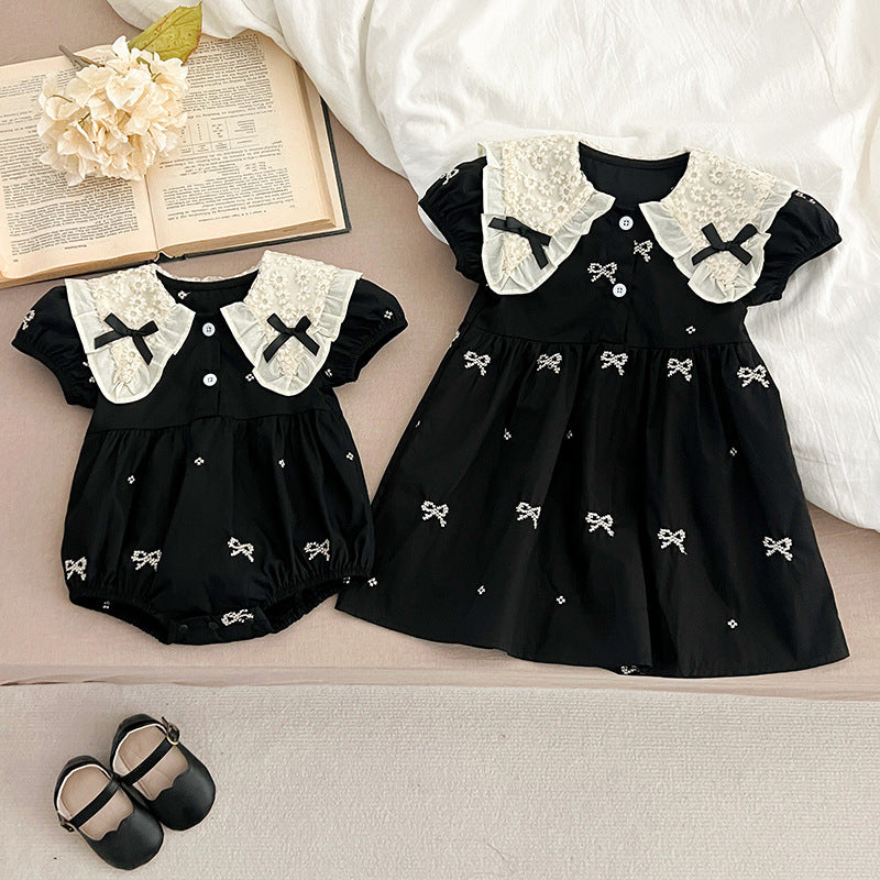 A cute summer dress for baby girls featuring a floral pattern and collar, available in black and apricot colors.