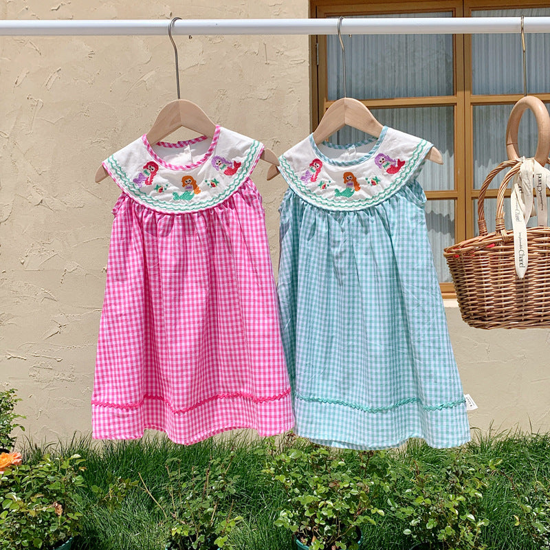 A cute summer dress for baby girls featuring a plaid pattern and mermaid embroidery in pink and blue colors.