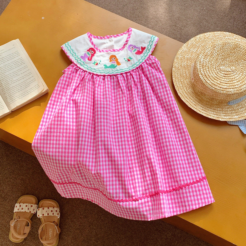 A cute summer dress for baby girls featuring a plaid pattern and mermaid embroidery in pink and blue colors.