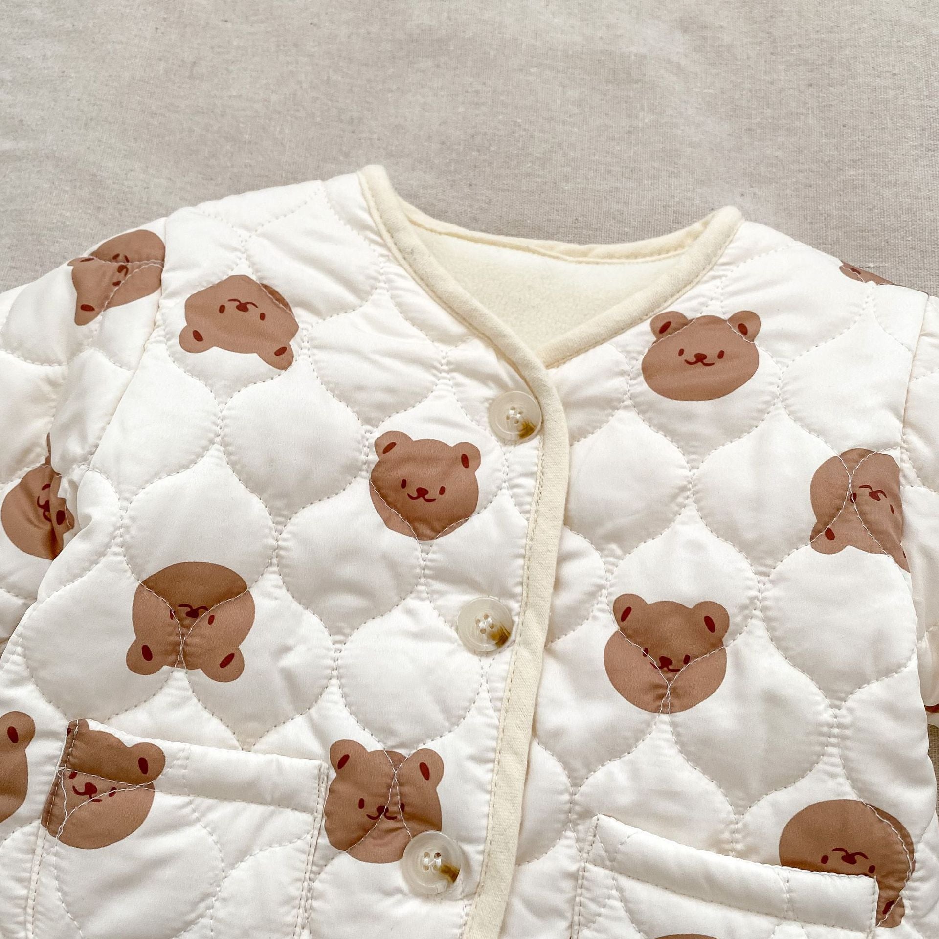 A cute winter baby long sleeve top featuring a bear head design, made of thick warm cotton, suitable for both boys and girls.