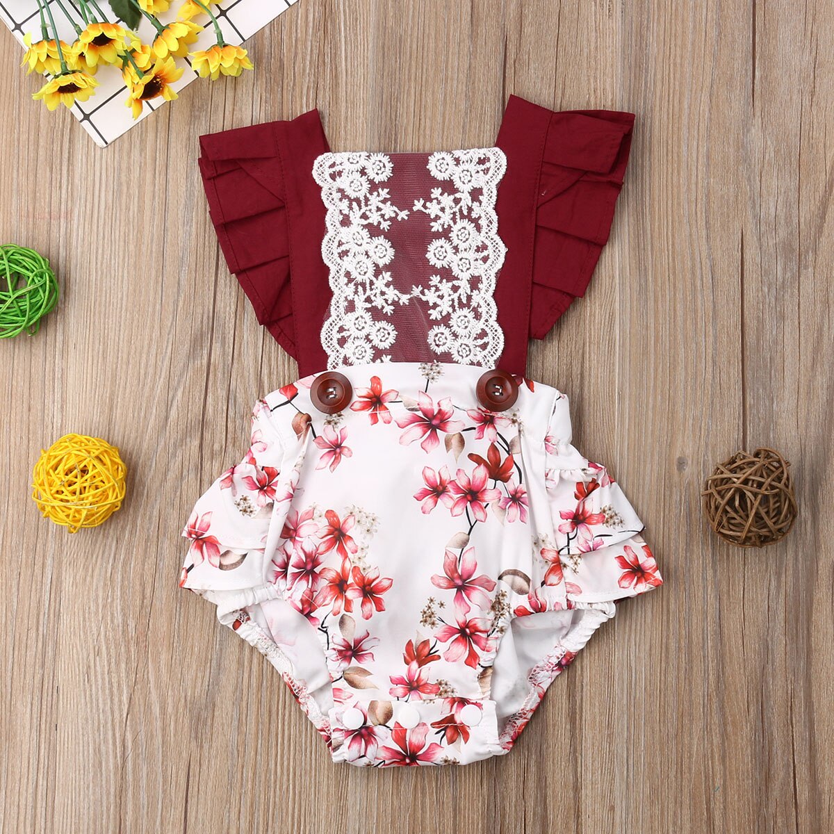 Floral baby romper with lace.