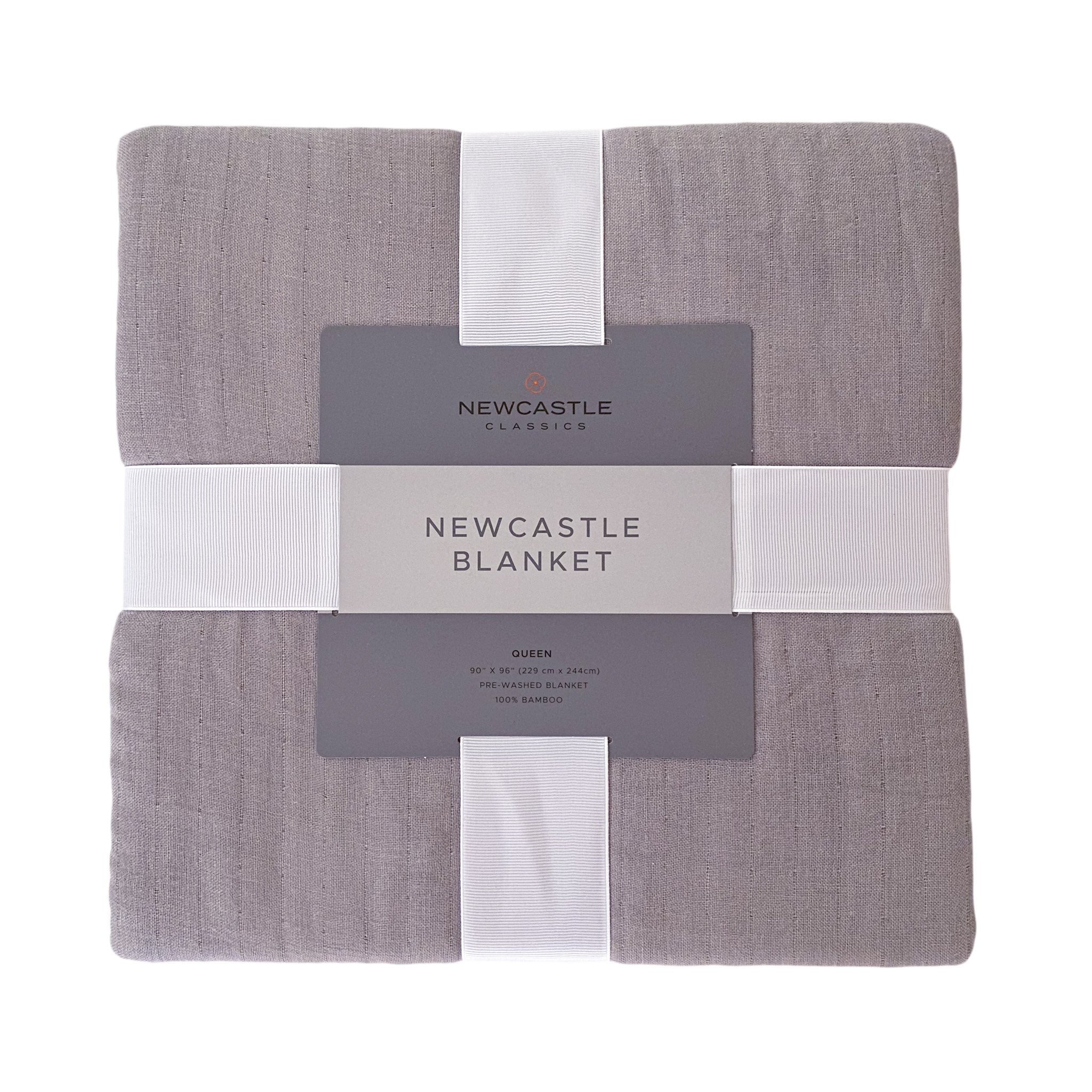 Newcastle Grey Oversized King Luxury Bamboo Bed Blanket draped elegantly on a bed, showcasing its soft texture and stylish grey color.