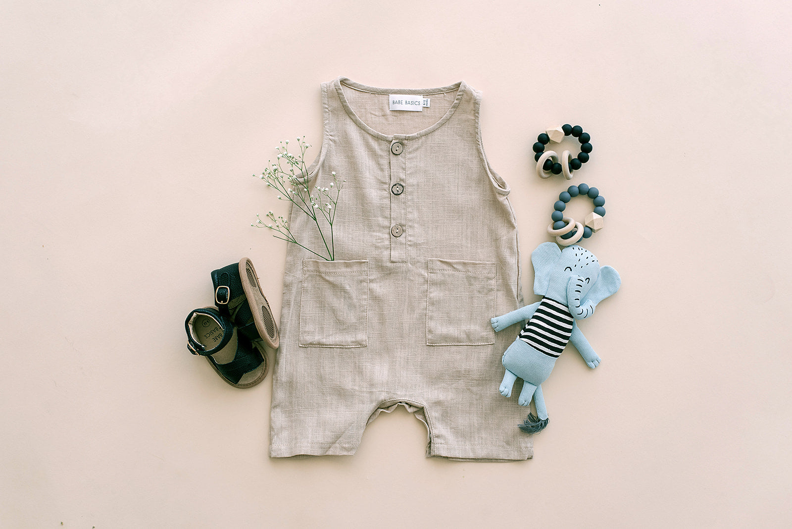 Oatmeal Cropped Linen Baby Romper featuring soft linen fabric and diaper snaps, perfect for stylish summer wear.