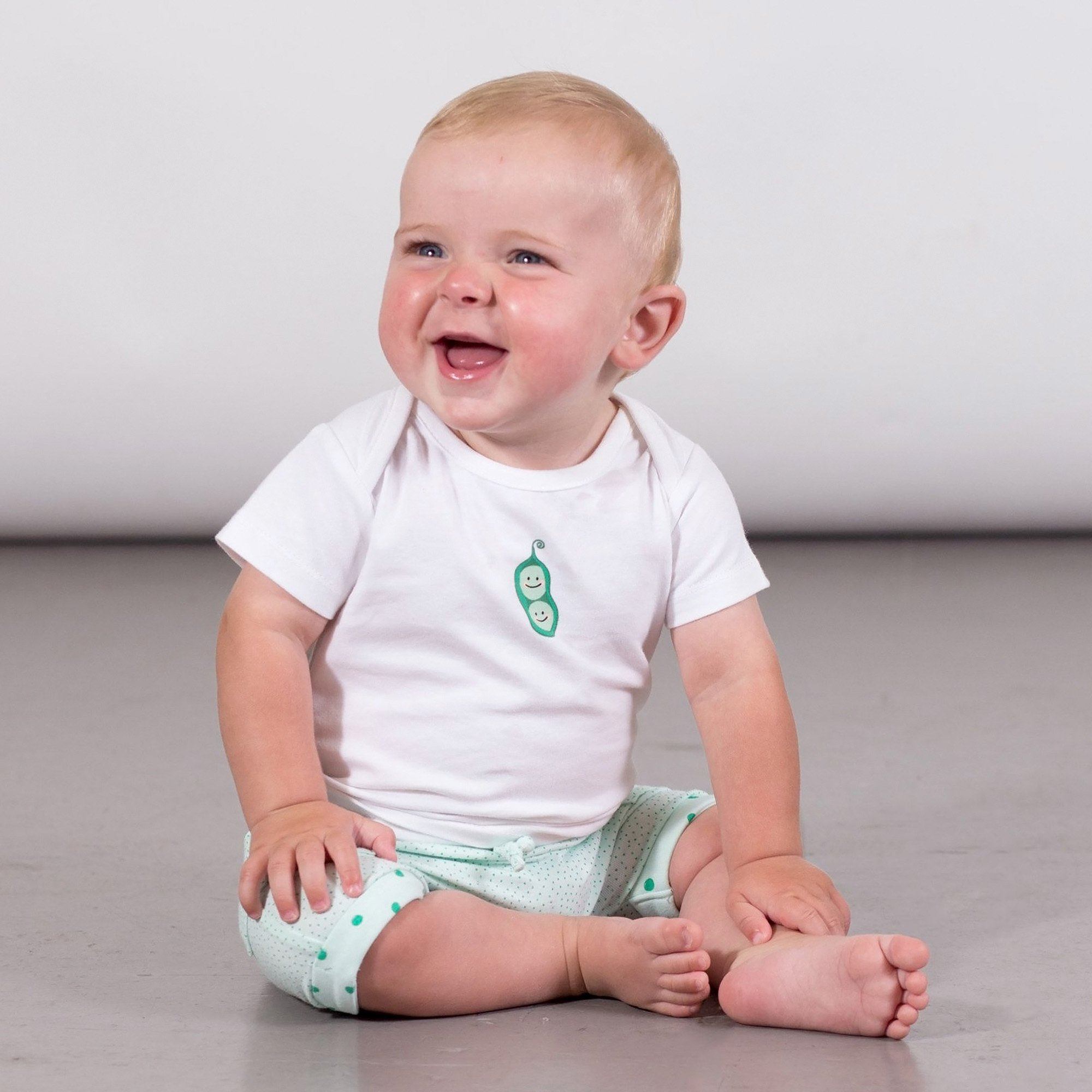 A cute Organic Cotton Top and Short Set featuring a pea pod print tee and polka dot shorts, perfect for kids.