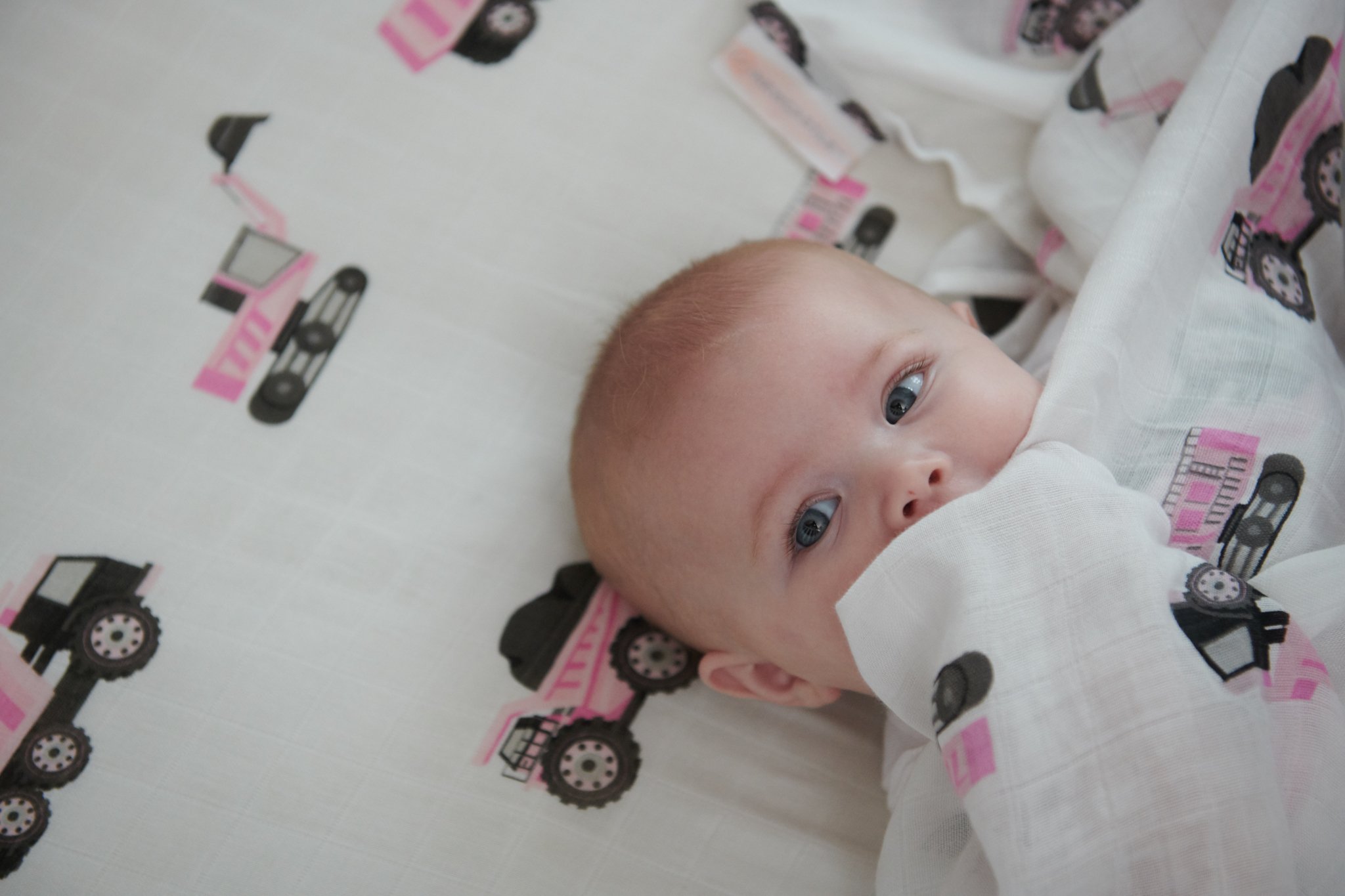 Pink Digger Bamboo Crib Sheet made from soft, breathable bamboo muslin, designed for standard crib mattresses.