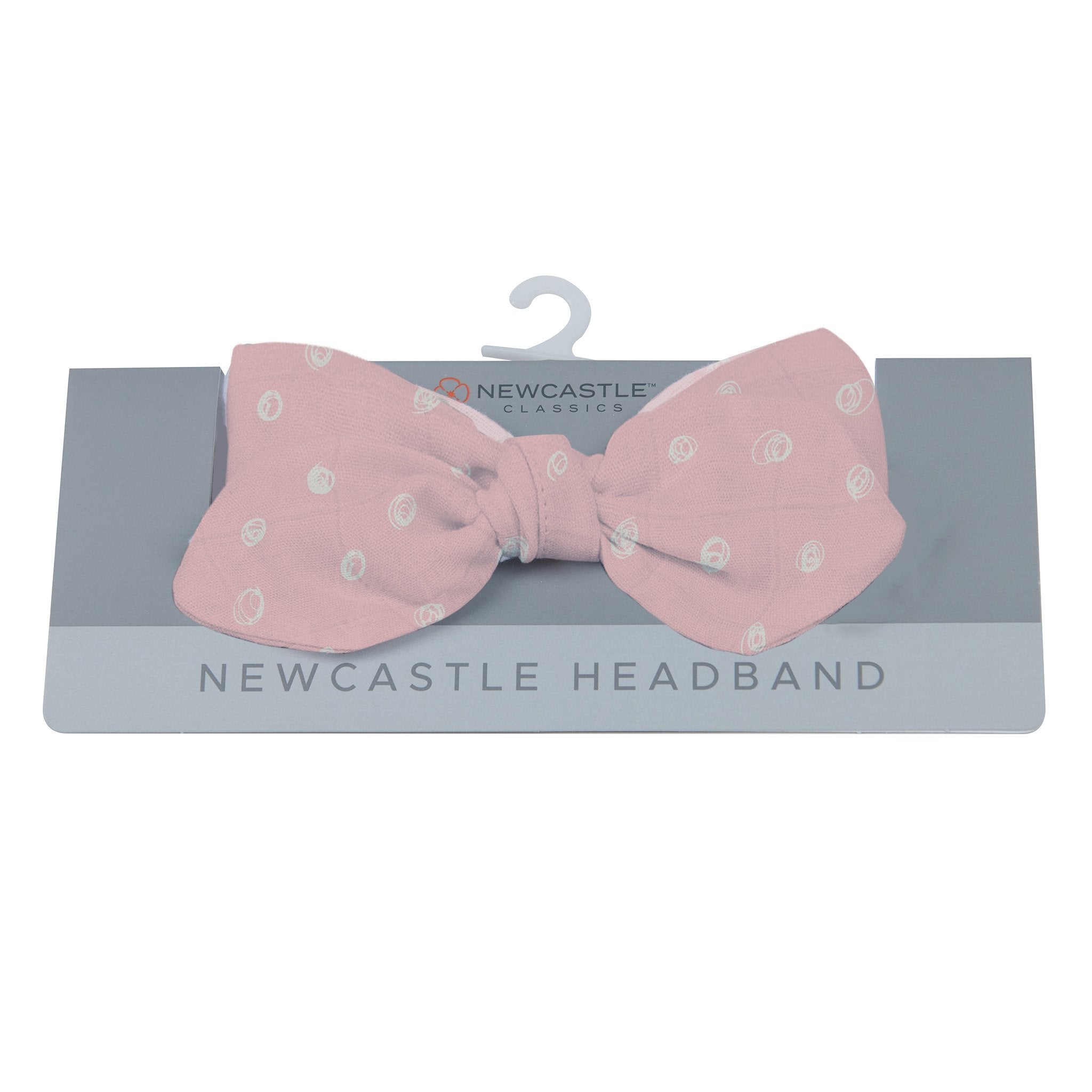 A stylish pink pearl polka dot headband made from soft bamboo fabric, perfect for casual and active wear.