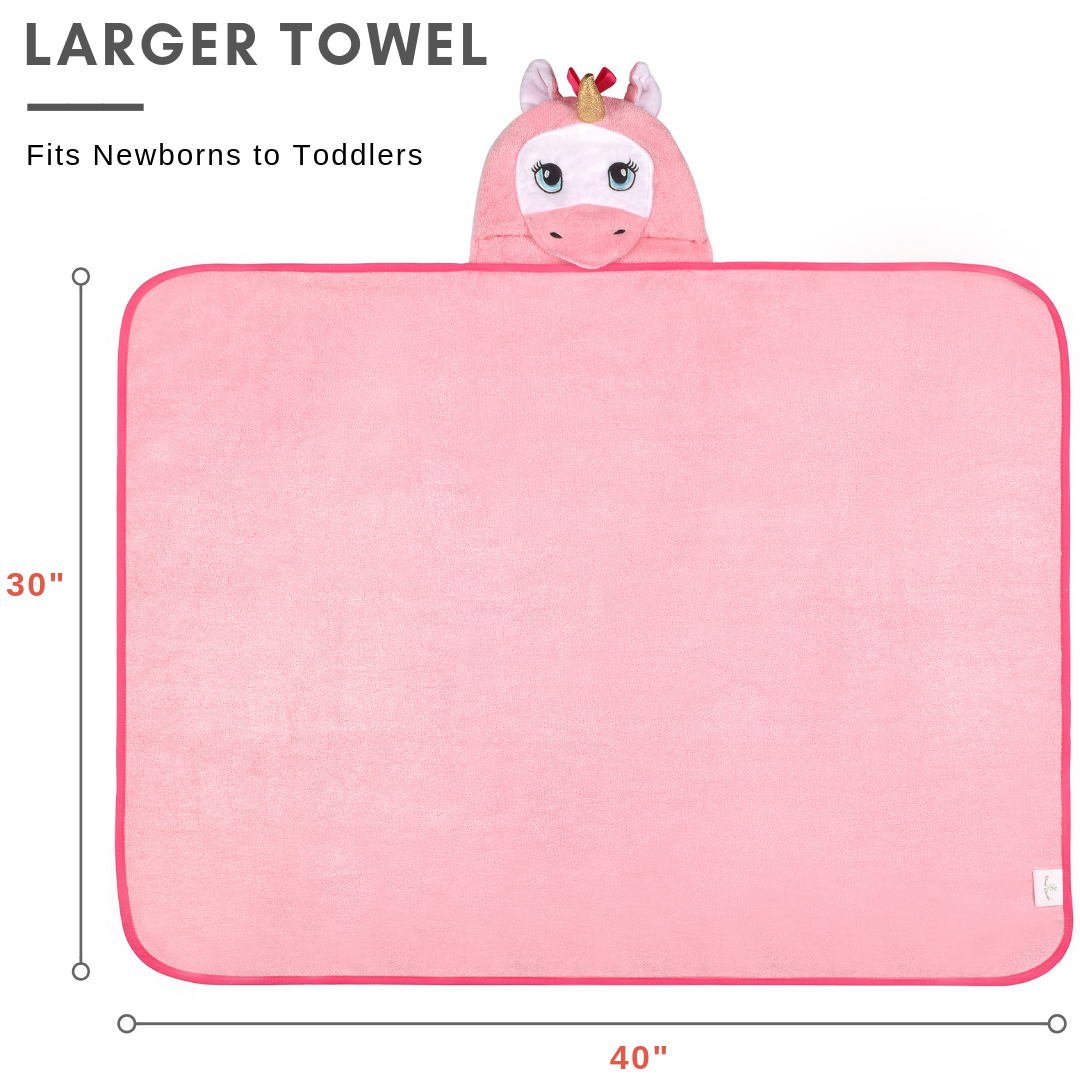 A soft and plush pink unicorn hooded towel designed for babies, featuring a cute unicorn face and ears on the hood.