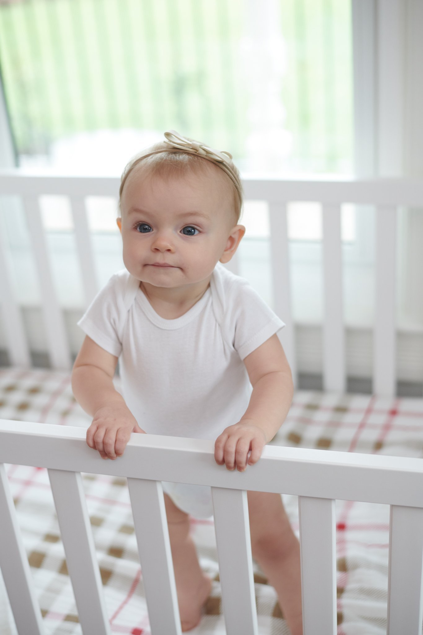 Plaid Cotton Muslin Crib Sheet in a cozy nursery setting, showcasing its soft texture and stylish design.