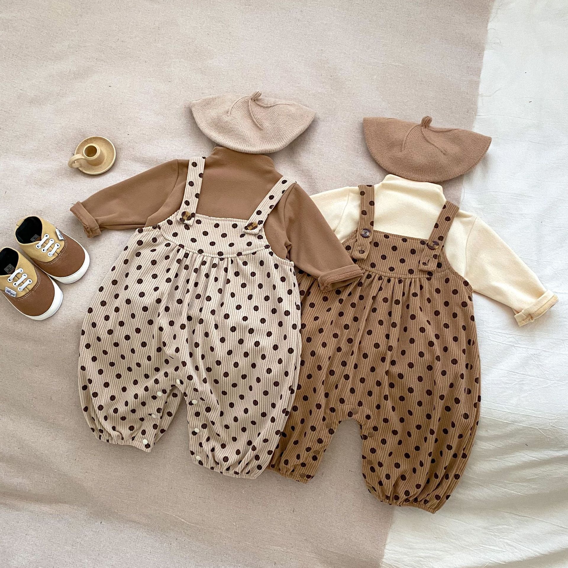 A set of polka dot overalls paired with solid color shirts in various colors, suitable for babies.