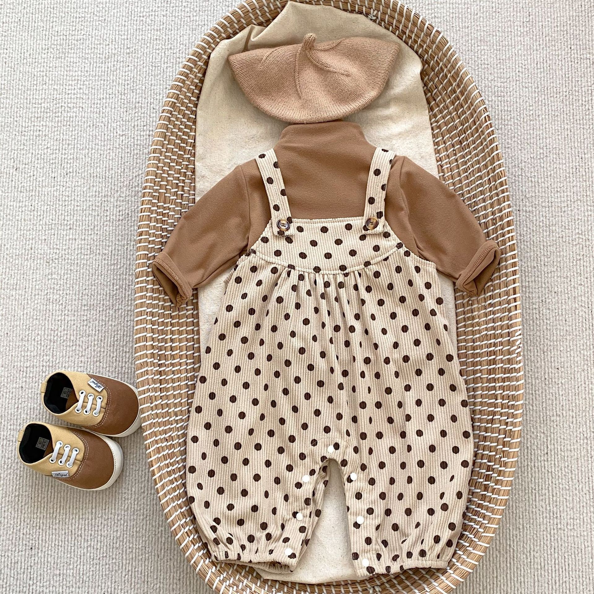 A set of polka dot overalls paired with solid color shirts in various colors, suitable for babies.