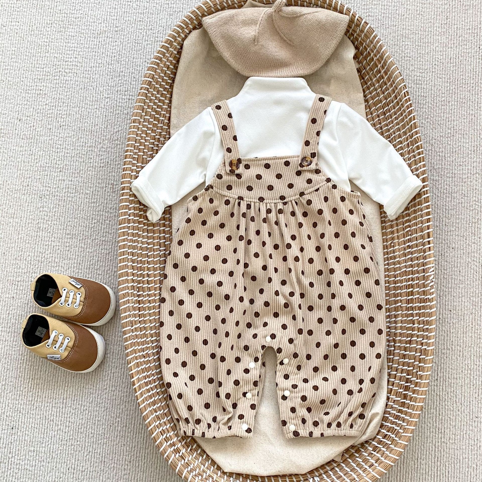 A set of polka dot overalls paired with solid color shirts in various colors, suitable for babies.