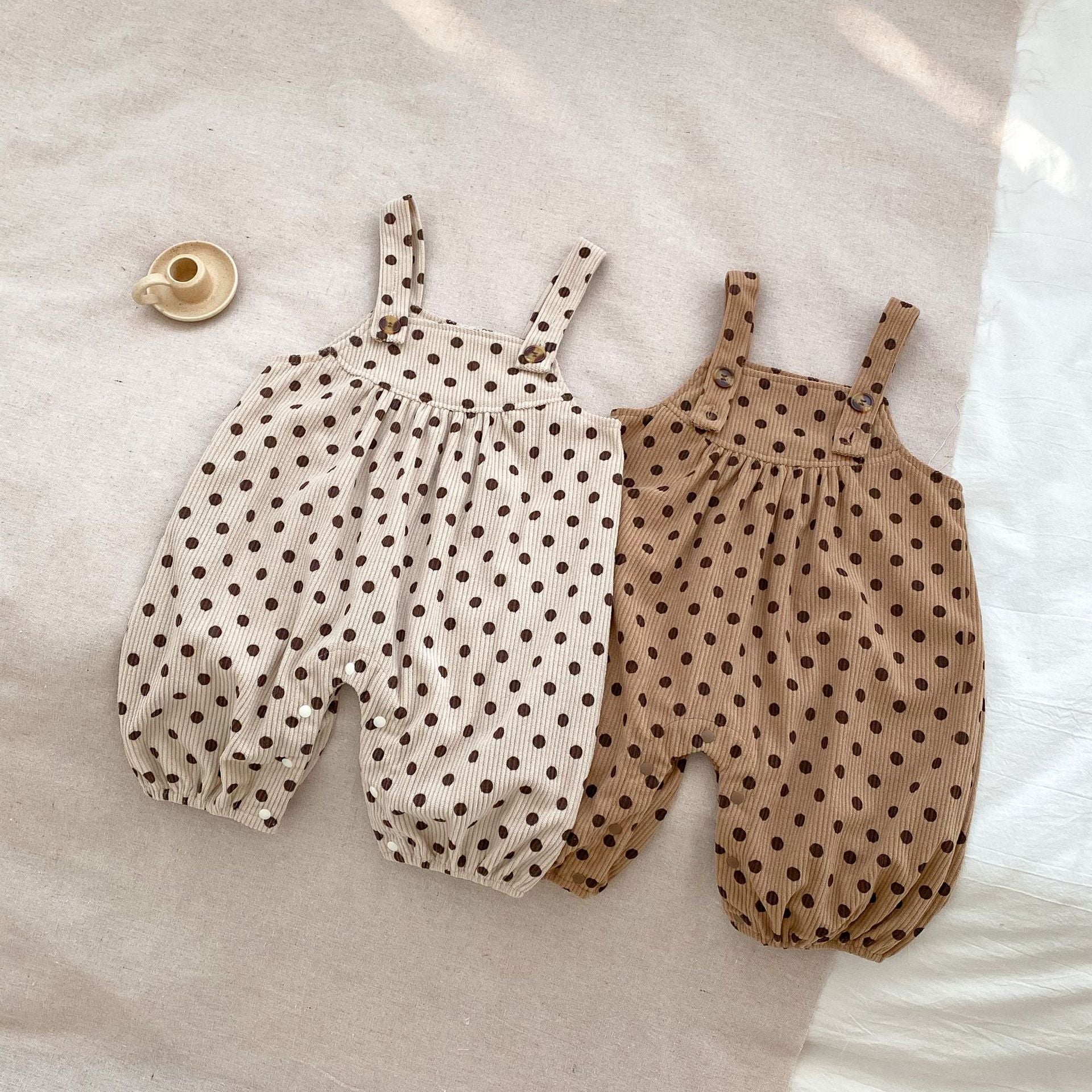 A set of polka dot overalls paired with solid color shirts in various colors, suitable for babies.