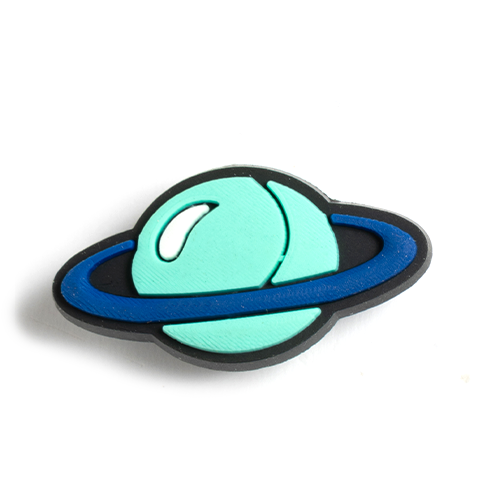 A colorful sensory toy shaped like the planet Saturn, featuring soft silicone bubbles for popping.