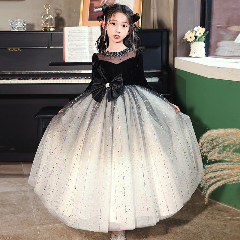 Luxurious long-sleeved black bow birthday dress for girls, featuring a charming dots pattern and made from a soft polyester blend.