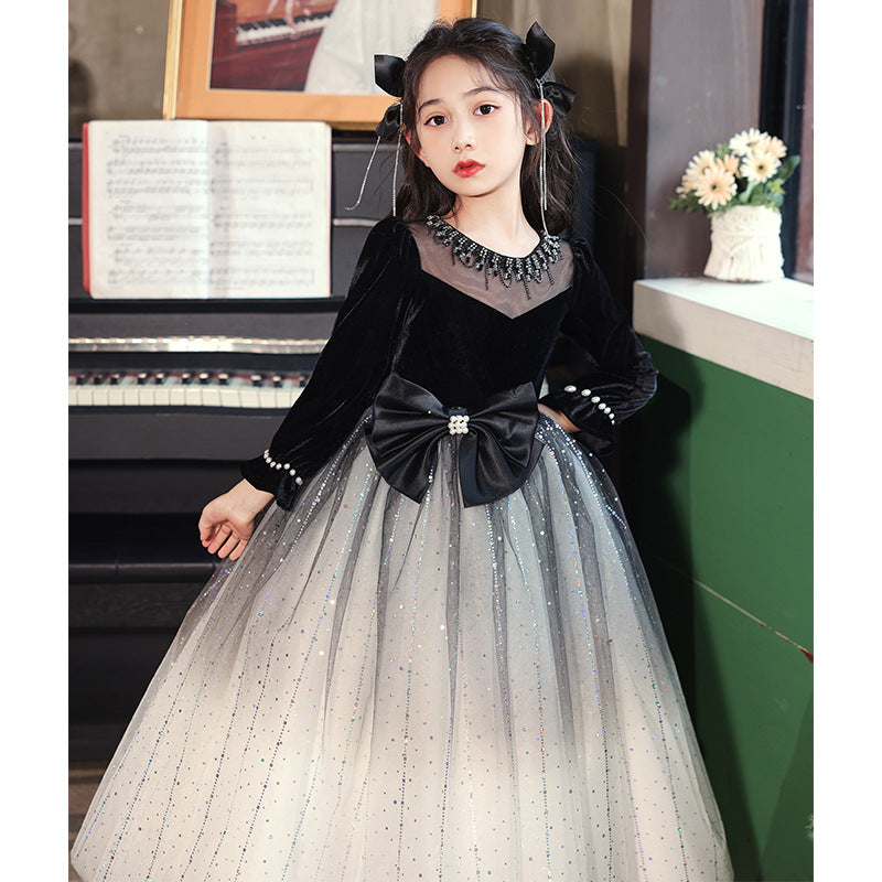 Luxurious long-sleeved black bow birthday dress for girls, featuring a charming dots pattern and made from a soft polyester blend.