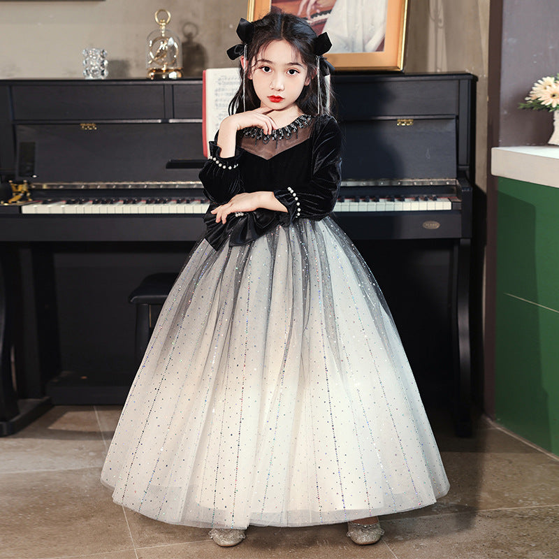 Luxurious long-sleeved black bow birthday dress for girls, featuring a charming dots pattern and made from a soft polyester blend.