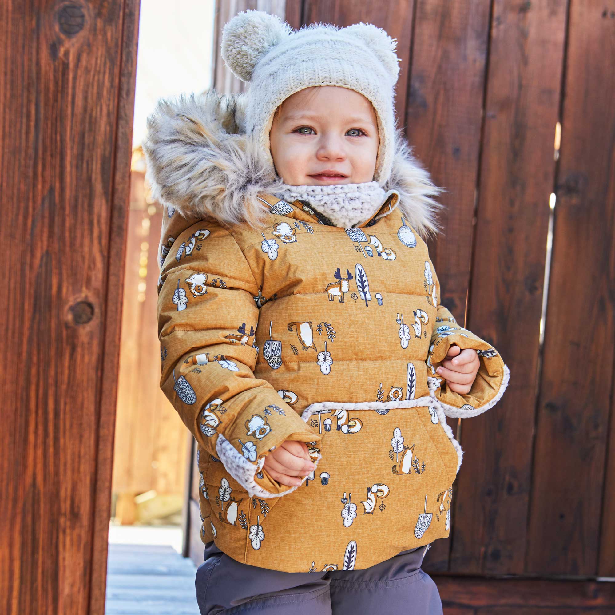 A vibrant yellow two-piece baby snowsuit featuring woodland animal prints, with a fleece-lined jacket and solid pants, perfect for winter wear.