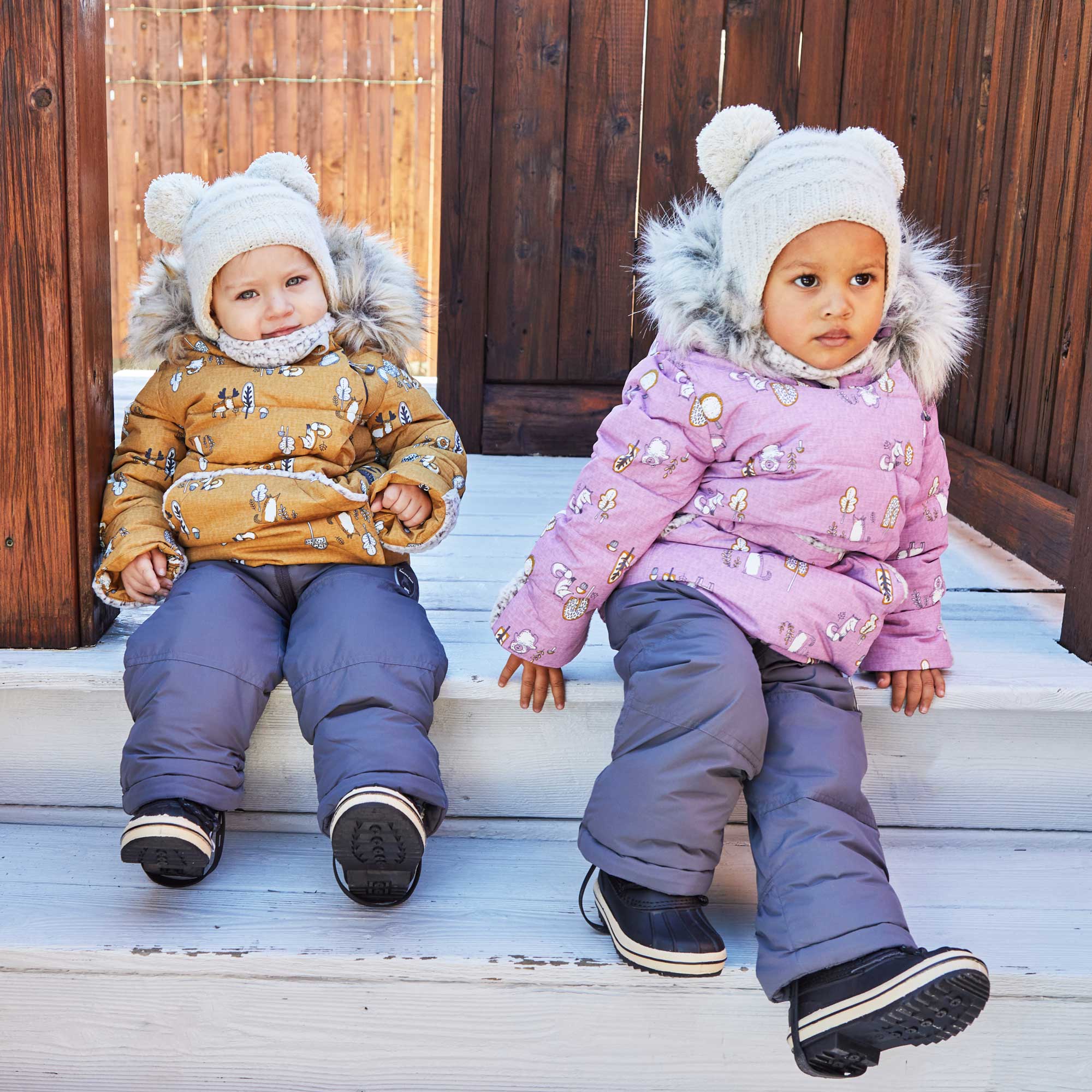 A vibrant yellow two-piece baby snowsuit featuring woodland animal prints, with a fleece-lined jacket and solid pants, perfect for winter wear.