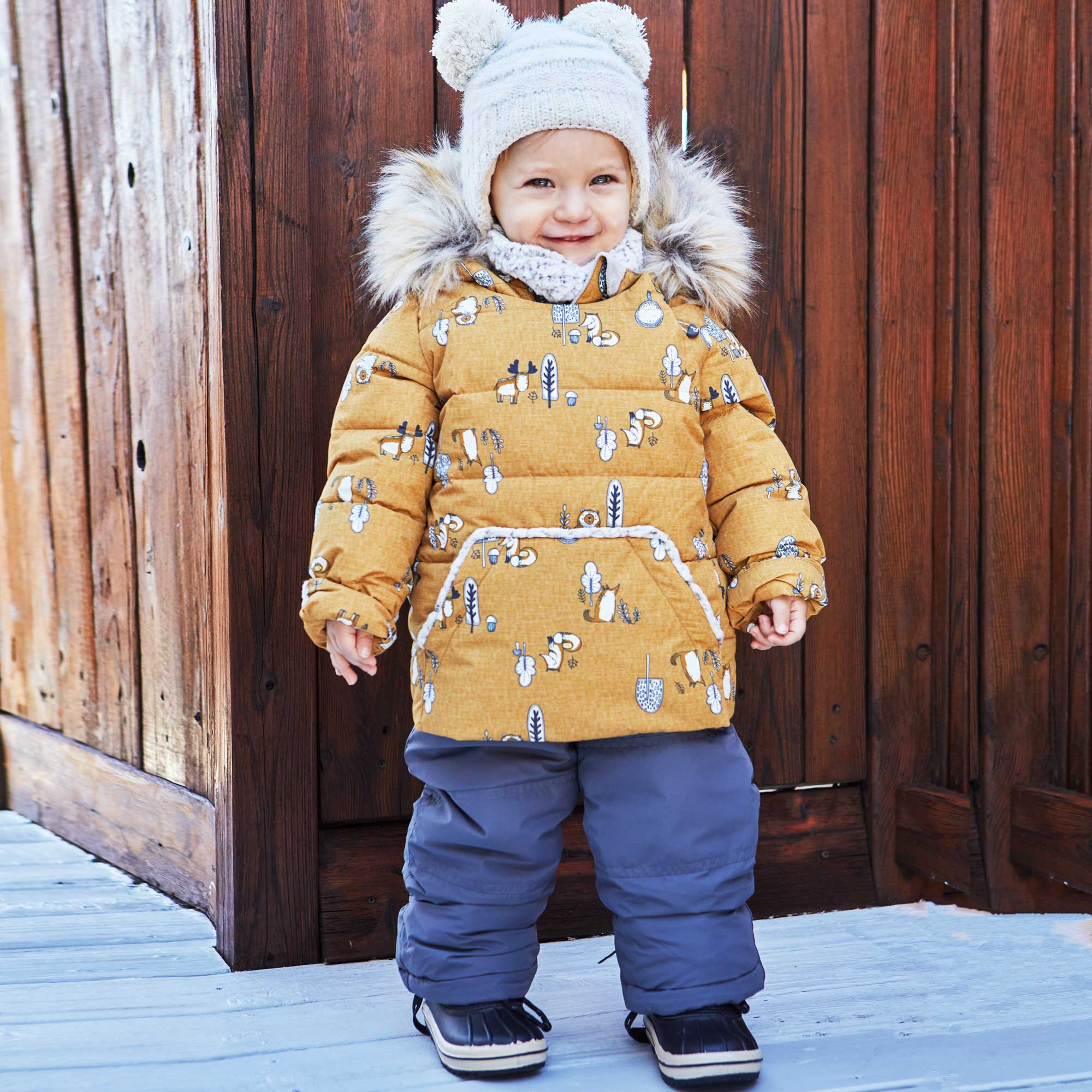 A vibrant yellow two-piece baby snowsuit featuring woodland animal prints, with a fleece-lined jacket and solid pants, perfect for winter wear.