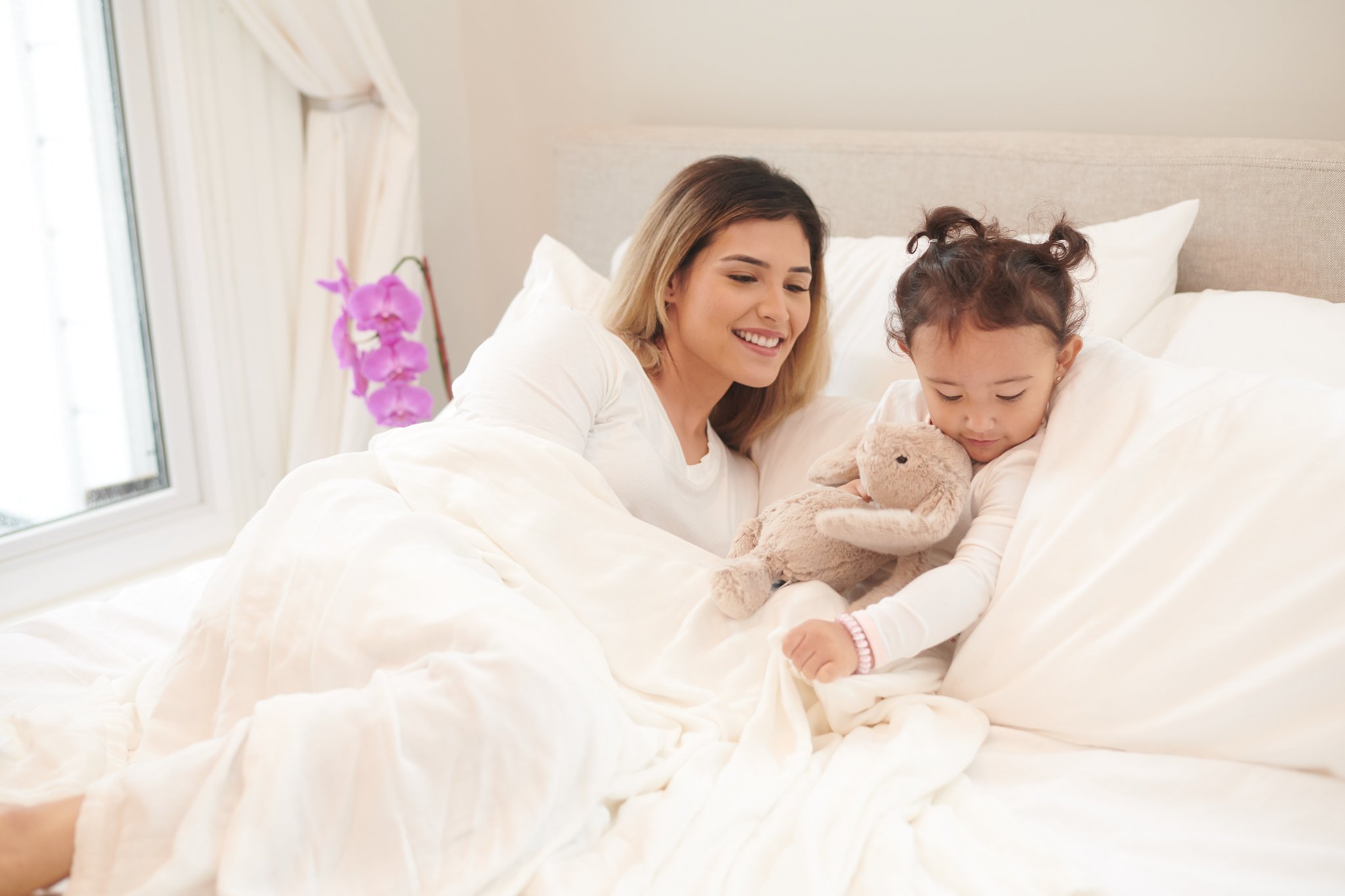 Pristine White Oversized King Luxury Bamboo Muslin Bed Blanket displayed on a bed, showcasing its soft texture and elegant design.