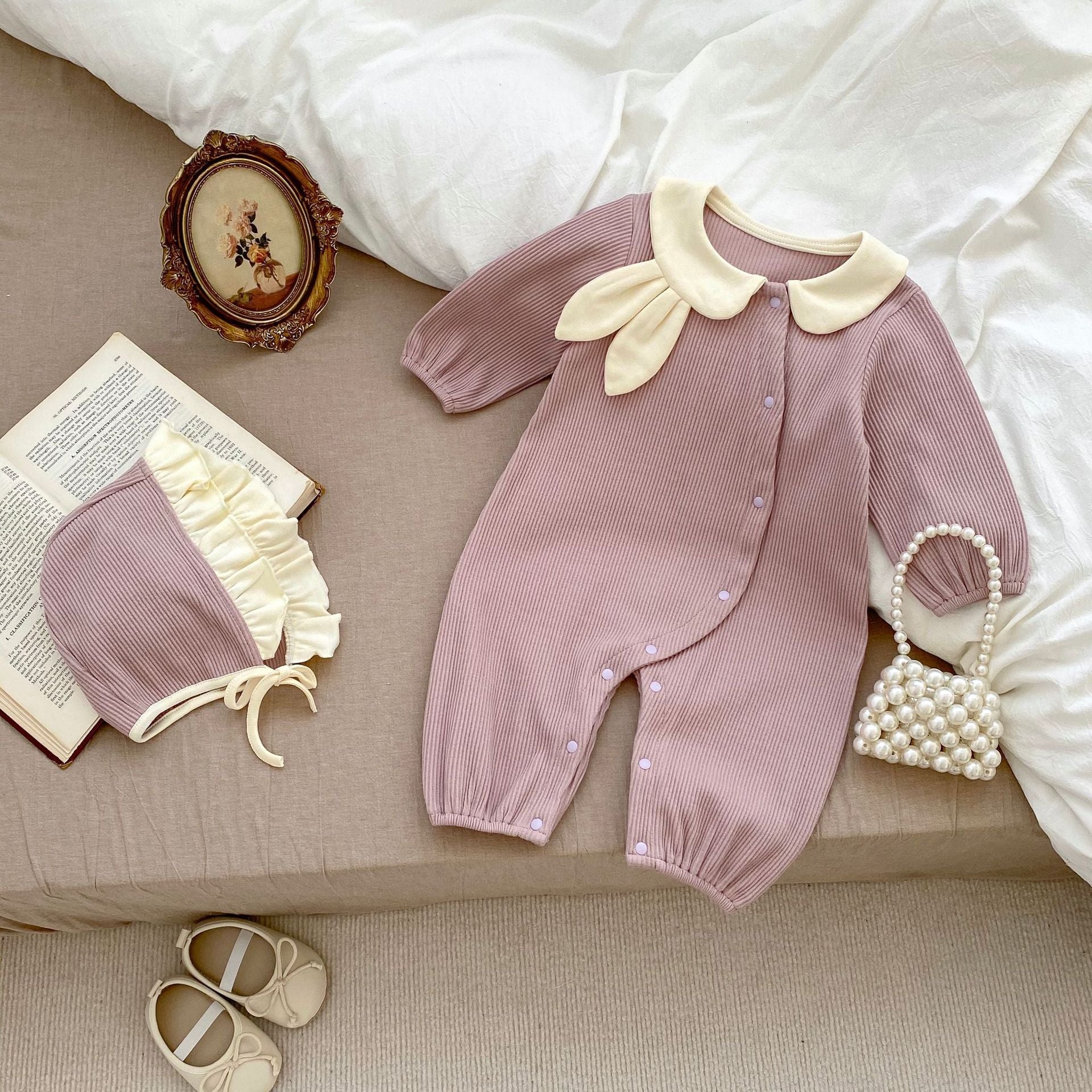 Adorable baby girl wearing a Rabbit Design Lapel Autumn Romper in purple, showcasing its cute rabbit motif and stylish lapel.