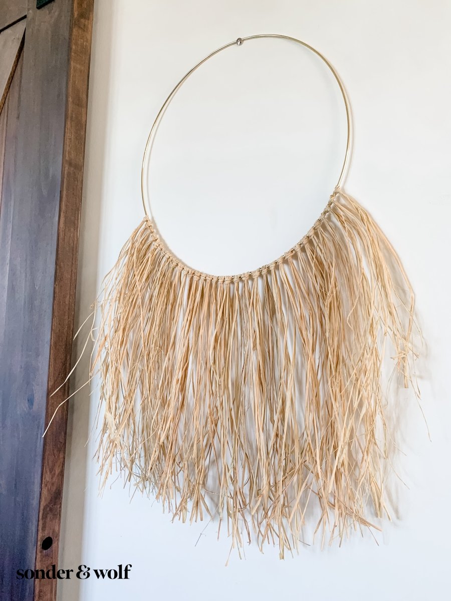 A beautifully crafted Raffia Wall Hanging showcasing natural fibers in a bohemian style, perfect for home decor.