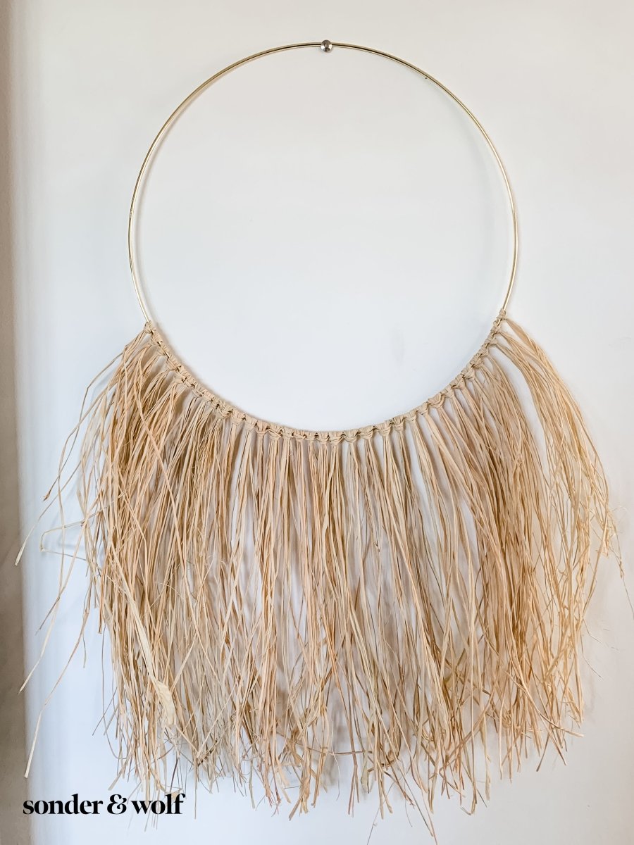 A beautifully crafted Raffia Wall Hanging showcasing natural fibers in a bohemian style, perfect for home decor.