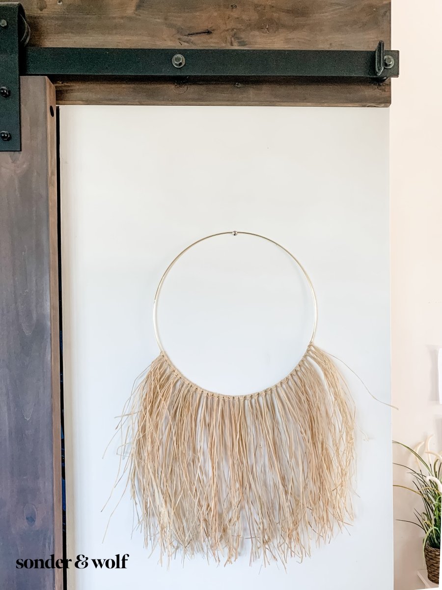 A beautifully crafted Raffia Wall Hanging showcasing natural fibers in a bohemian style, perfect for home decor.