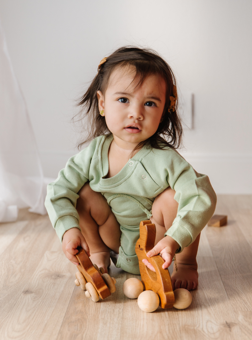 A soft and lightweight Rainbow Baby Bodysuit in grey and green, perfect for infants.