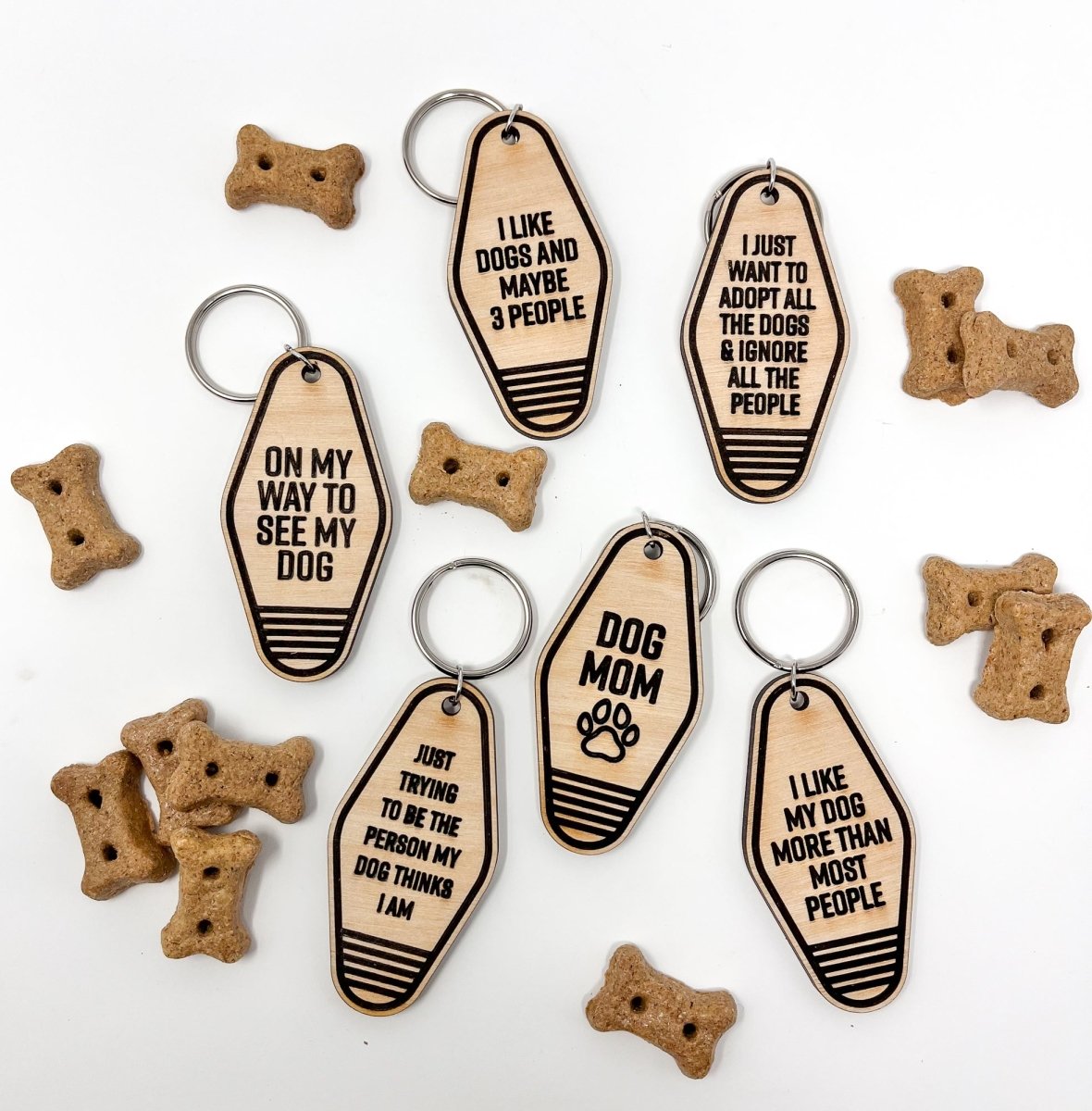 A collection of unique retro dog keychains made from natural wood, featuring laser-engraved designs and heartfelt messages for dog lovers.