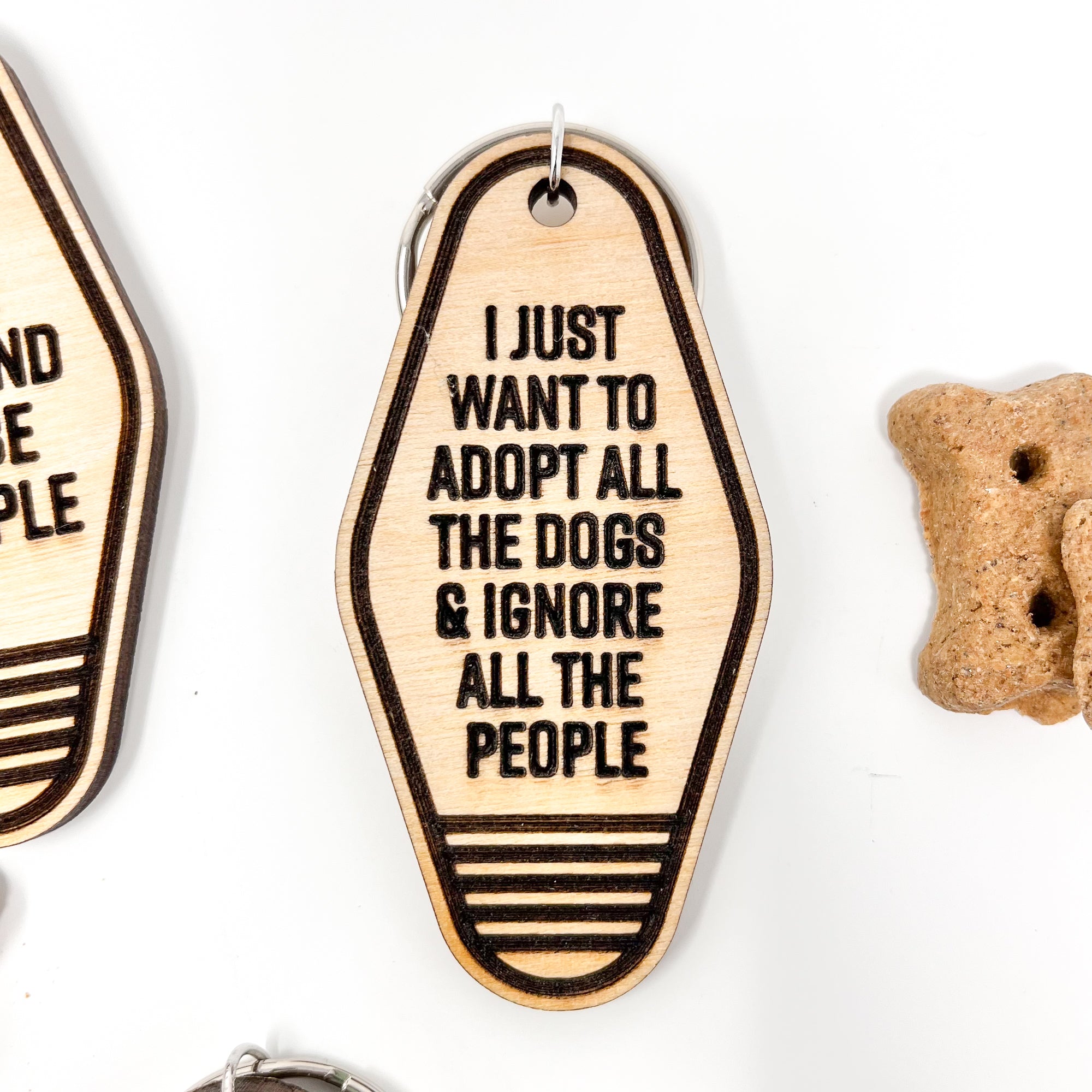 A collection of unique retro dog keychains made from natural wood, featuring laser-engraved designs and heartfelt messages for dog lovers.