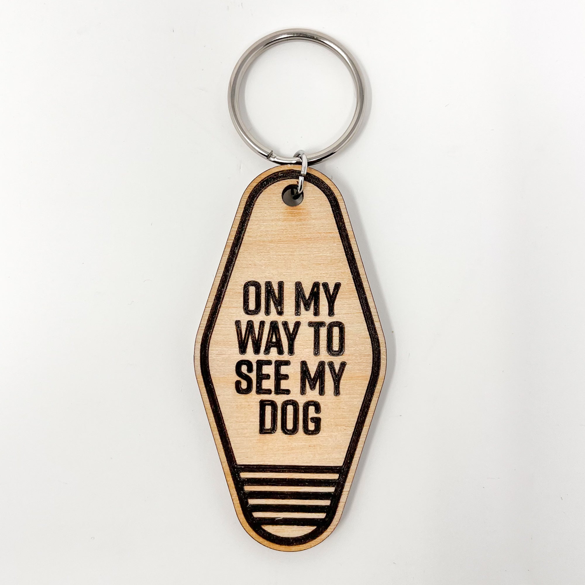 A collection of unique retro dog keychains made from natural wood, featuring laser-engraved designs and heartfelt messages for dog lovers.