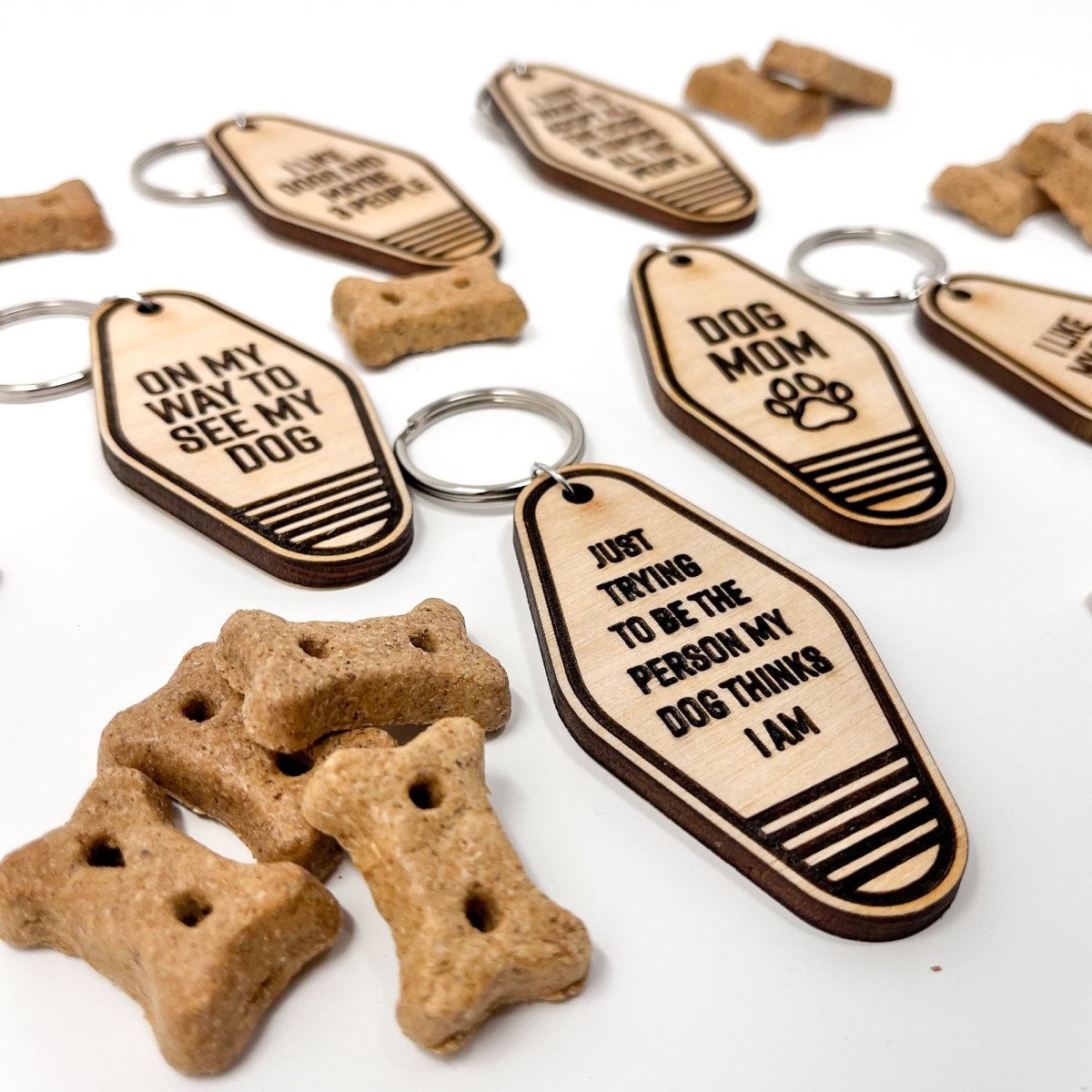 A collection of unique retro dog keychains made from natural wood, featuring laser-engraved designs and heartfelt messages for dog lovers.