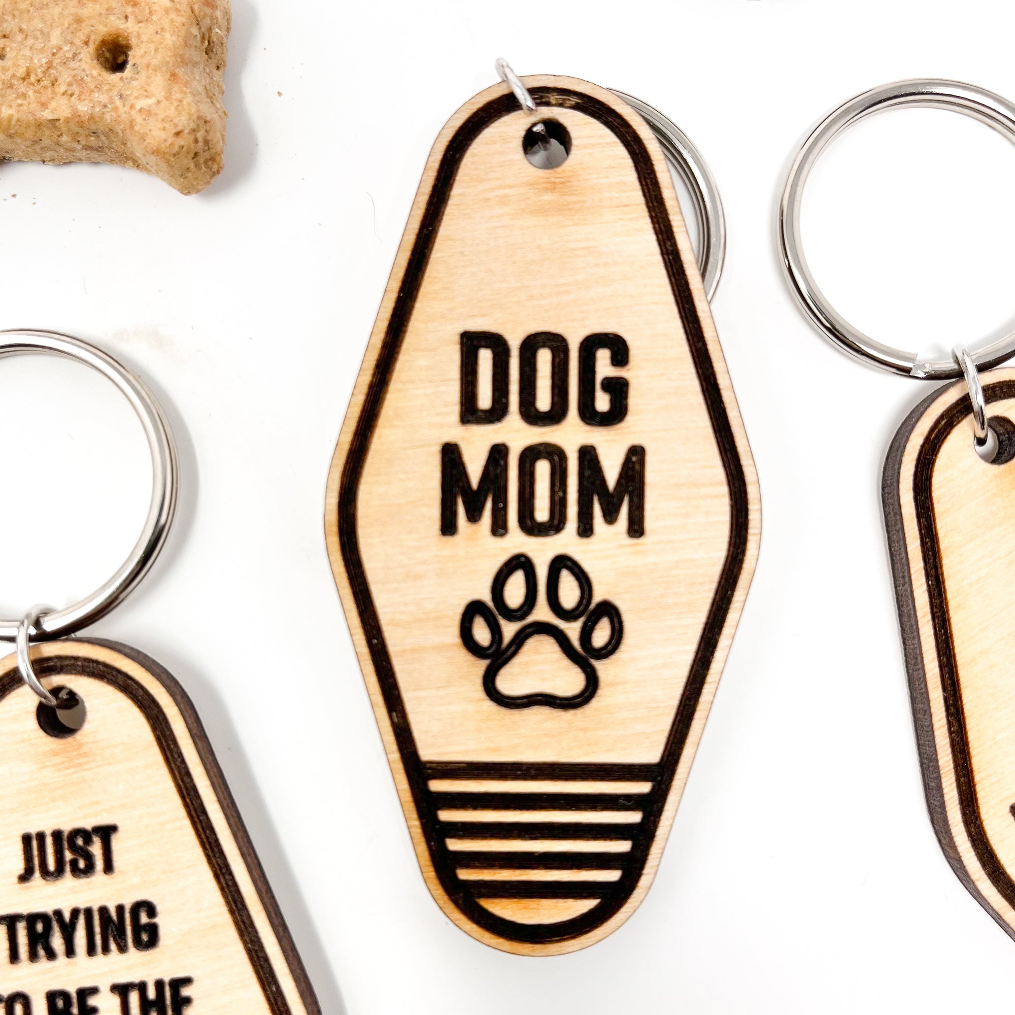 A collection of unique retro dog keychains made from natural wood, featuring laser-engraved designs and heartfelt messages for dog lovers.